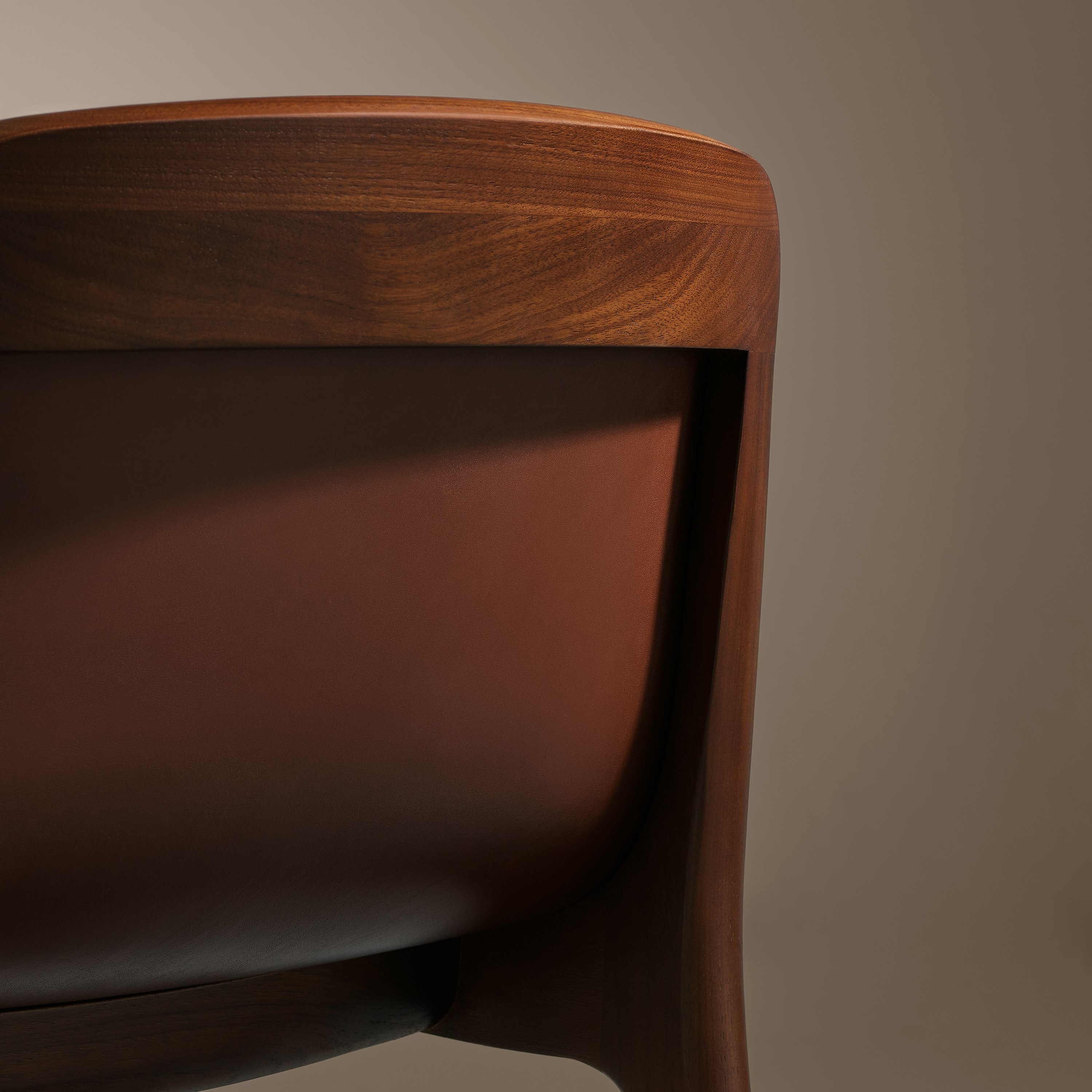 Lijn Stool by Carole Baijings for Geiger in Persian Walnut frame upholstered with Maharam Hue Leather in Bittersweet, detail shot on a neutral background.