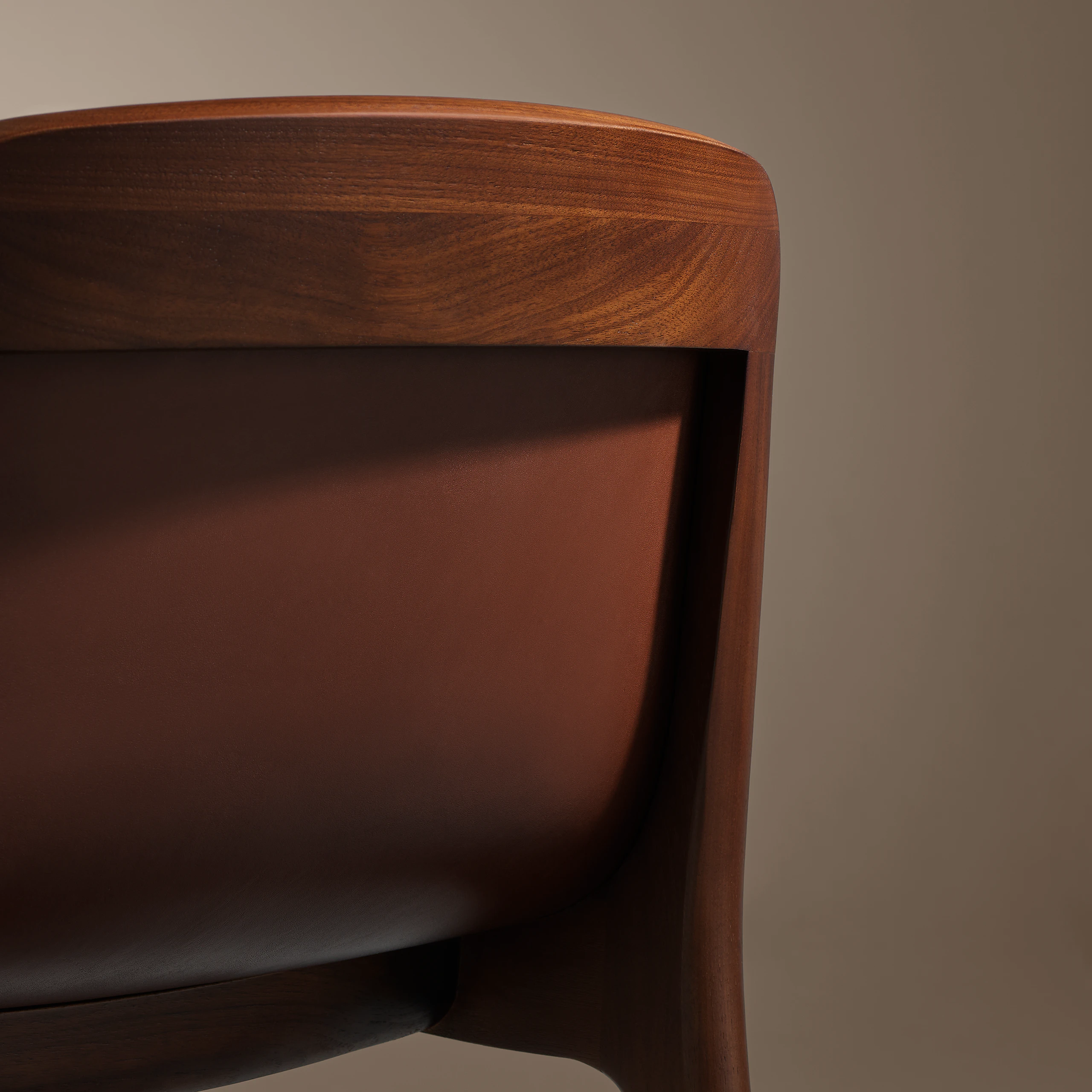 Lijn Stool by Carole Baijings for Geiger in Persian Walnut frame upholstered with Maharam Hue Leather in Bittersweet, detail shot on a neutral background.