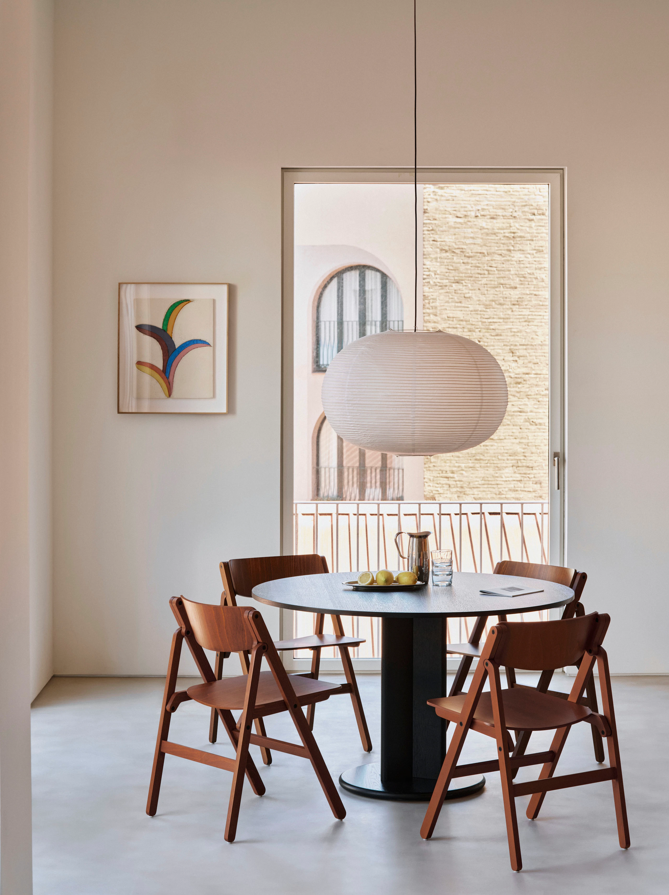 Four Backflip folding chairs around Chisel 29 Table