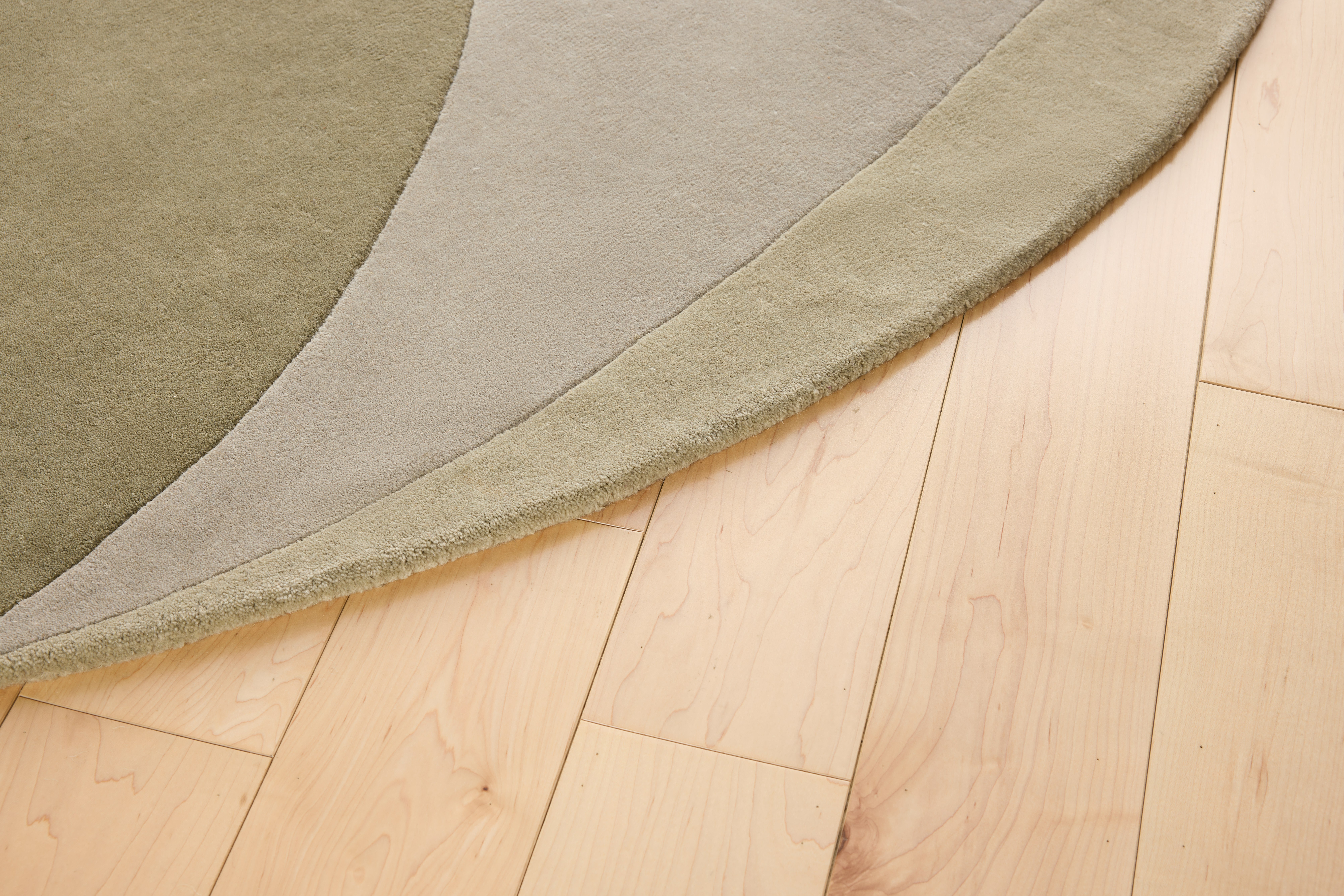 A detailed look at a Layers Rug in Sage.