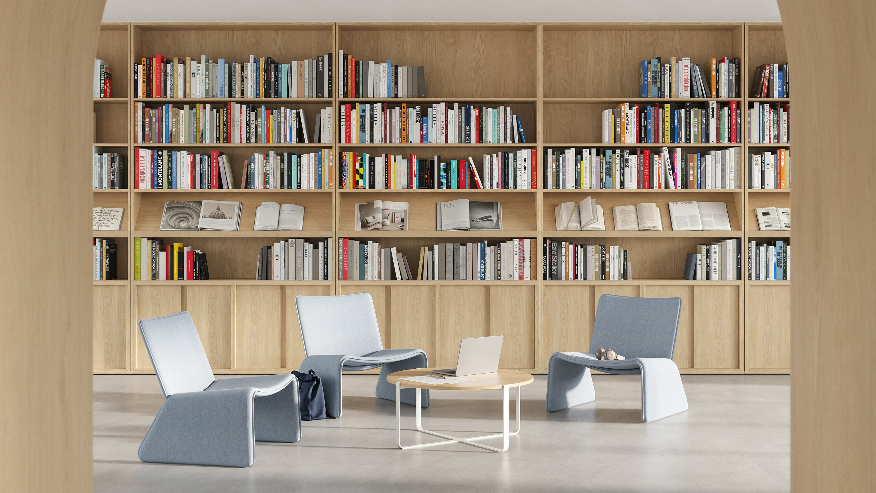 A group of Fin Lounge Chairs around a Trace Table in a library setting.