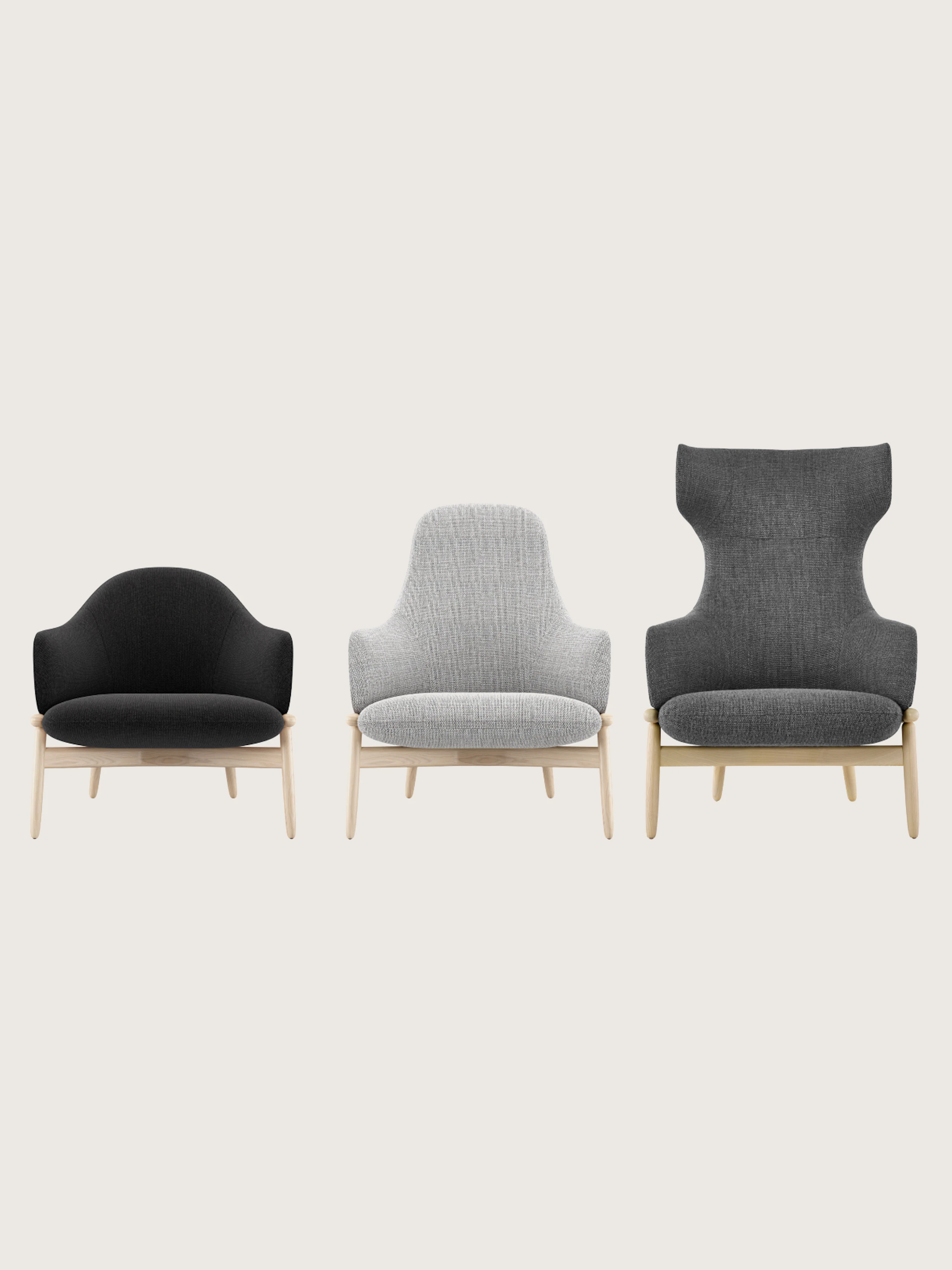 Three front-facing Reframe Lounge Chairs designed by EOOS with oak frames, one mid-back with black upholstery, one high-back with light grey upholstery, and one wing-back with dark grey upholstery, on a white sweep.