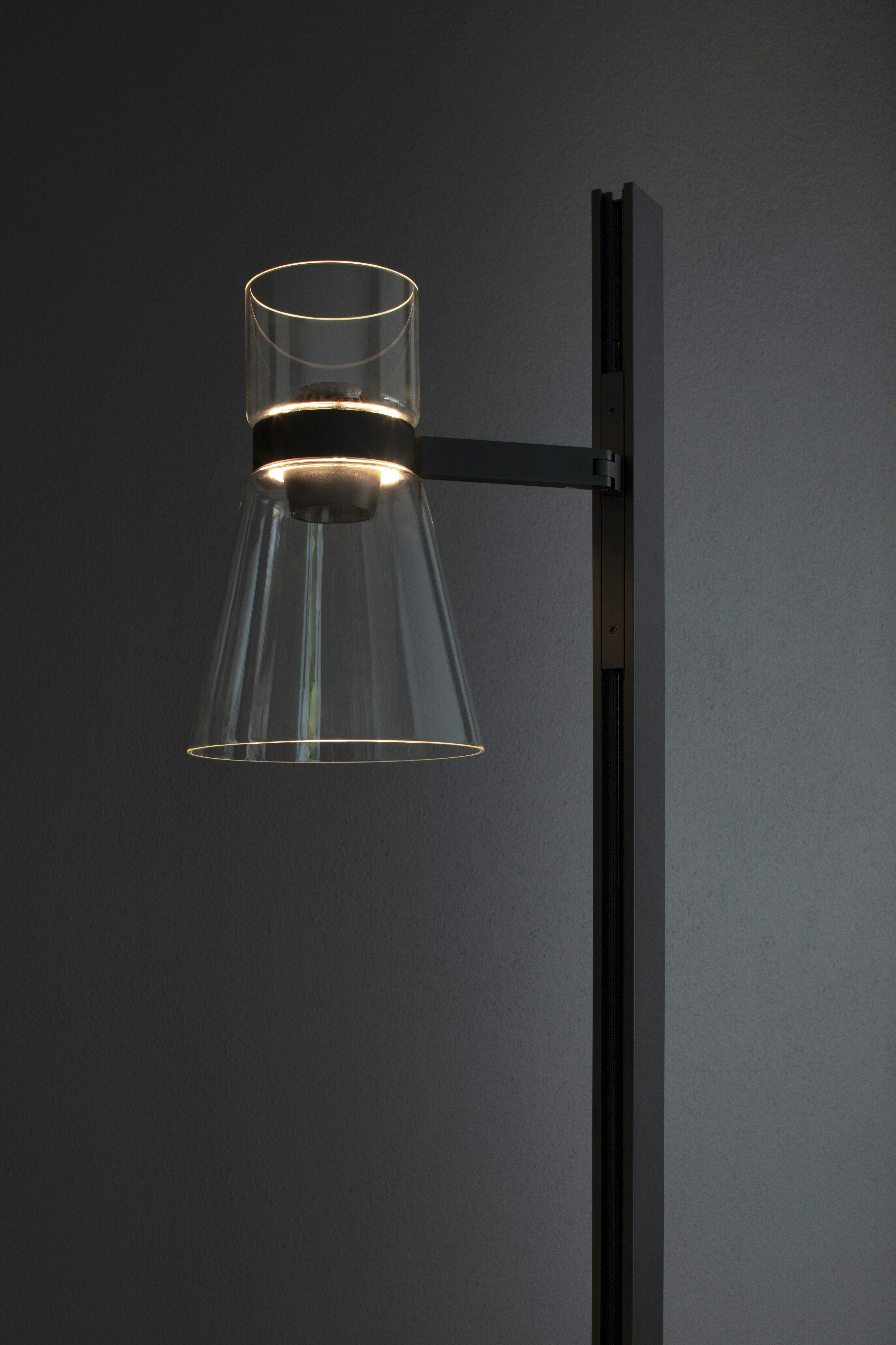 An environmental shot of Nocturne Floor Lamp in F1 Cone, Black.