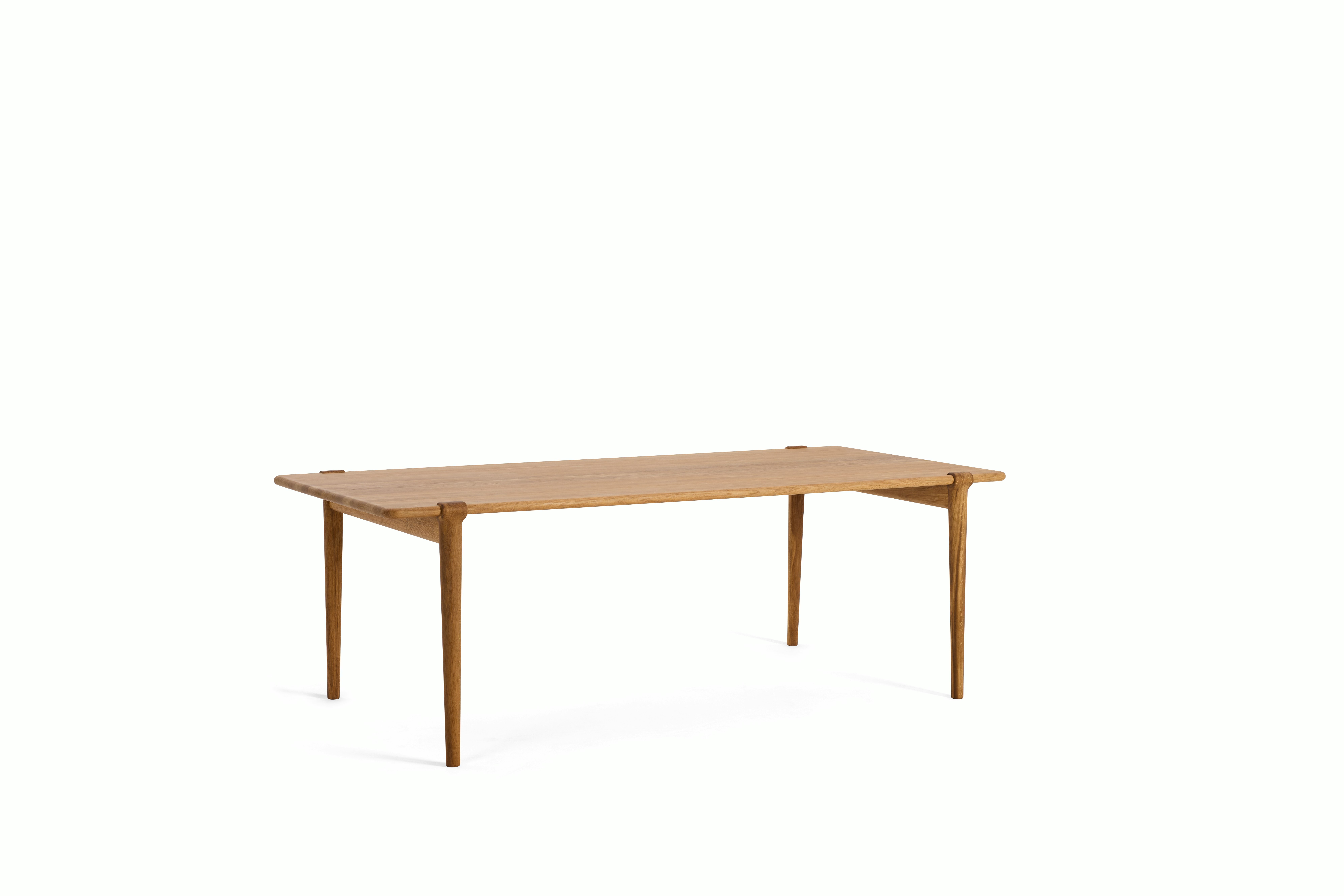 An Otto Dining Table in Oak viewed from an angle.