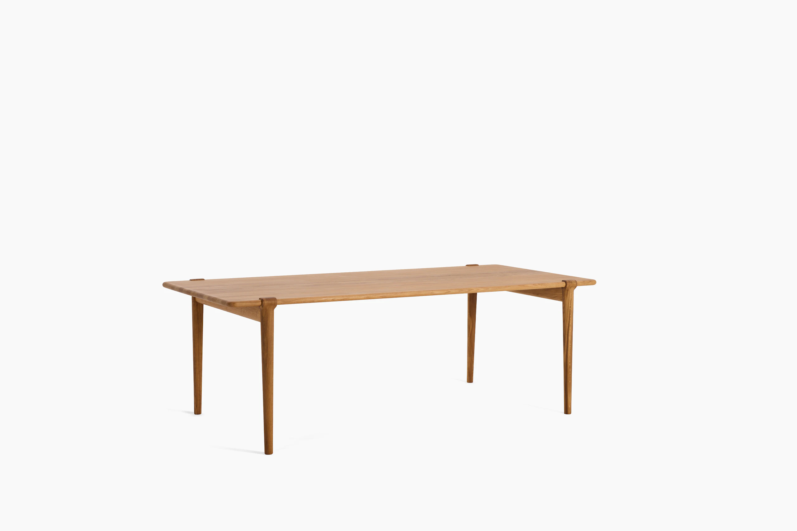 An Otto Dining Table in Oak viewed from an angle.