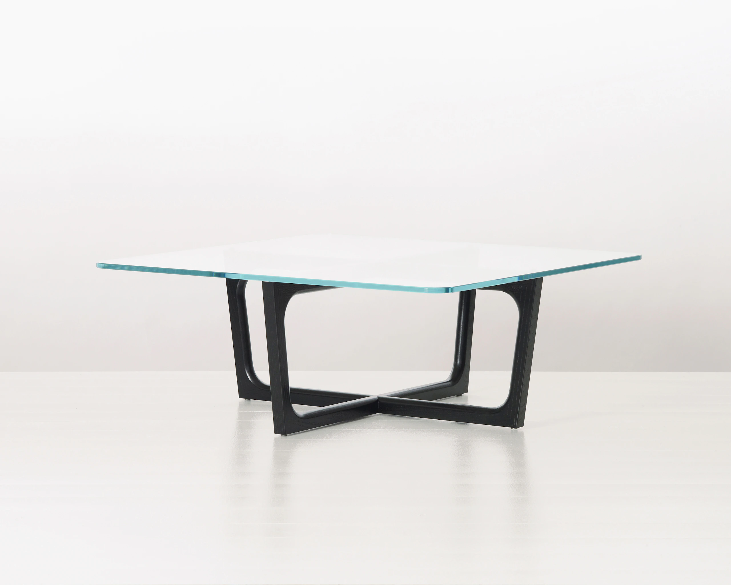 A square Loophole coffee table with a glass top and ebony-ash base.