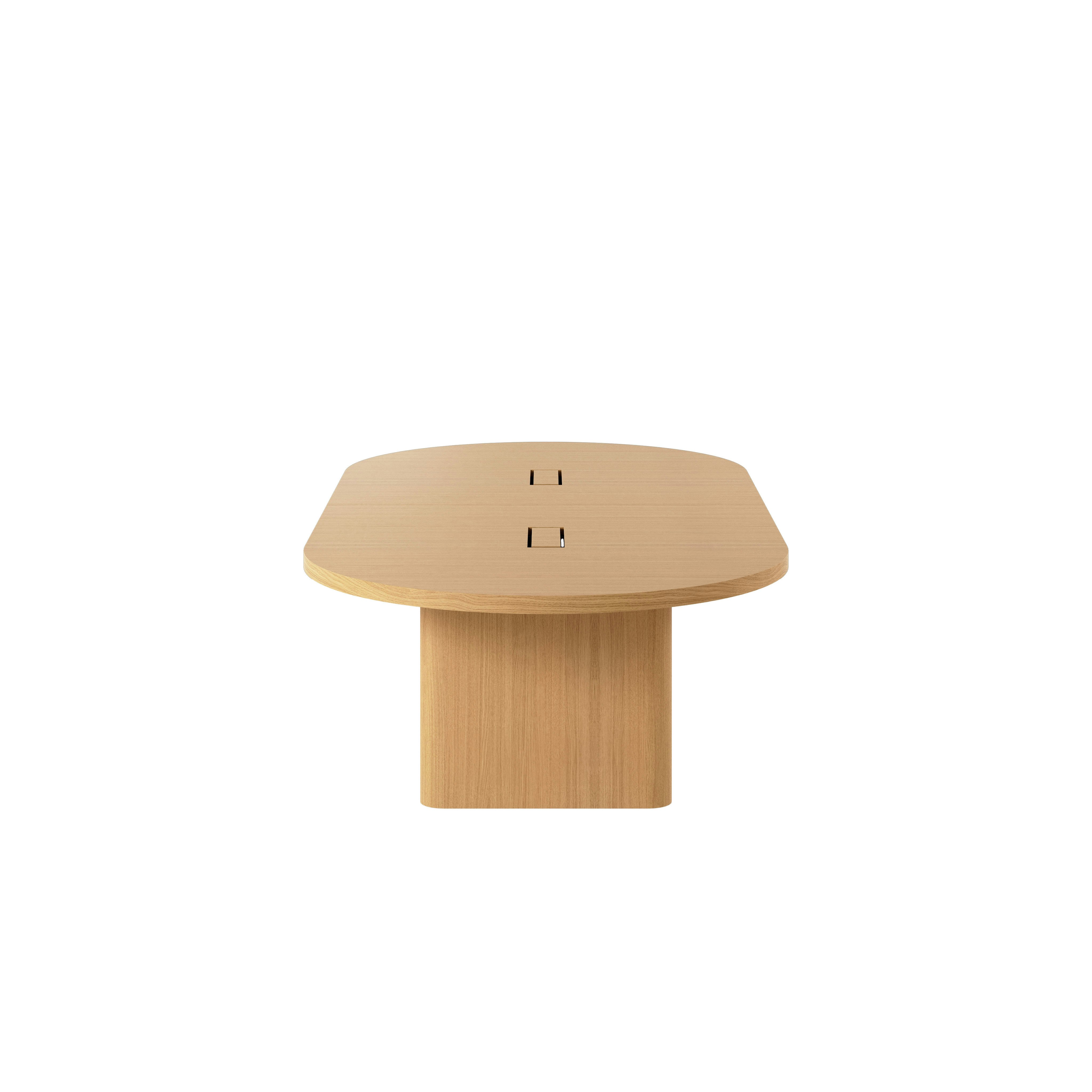 Racetrack-shaped JD Conference Table in Natural Rift Cut Oak with a 2 inch thick tabletop and racetrack-shaped bases viewed from the side.