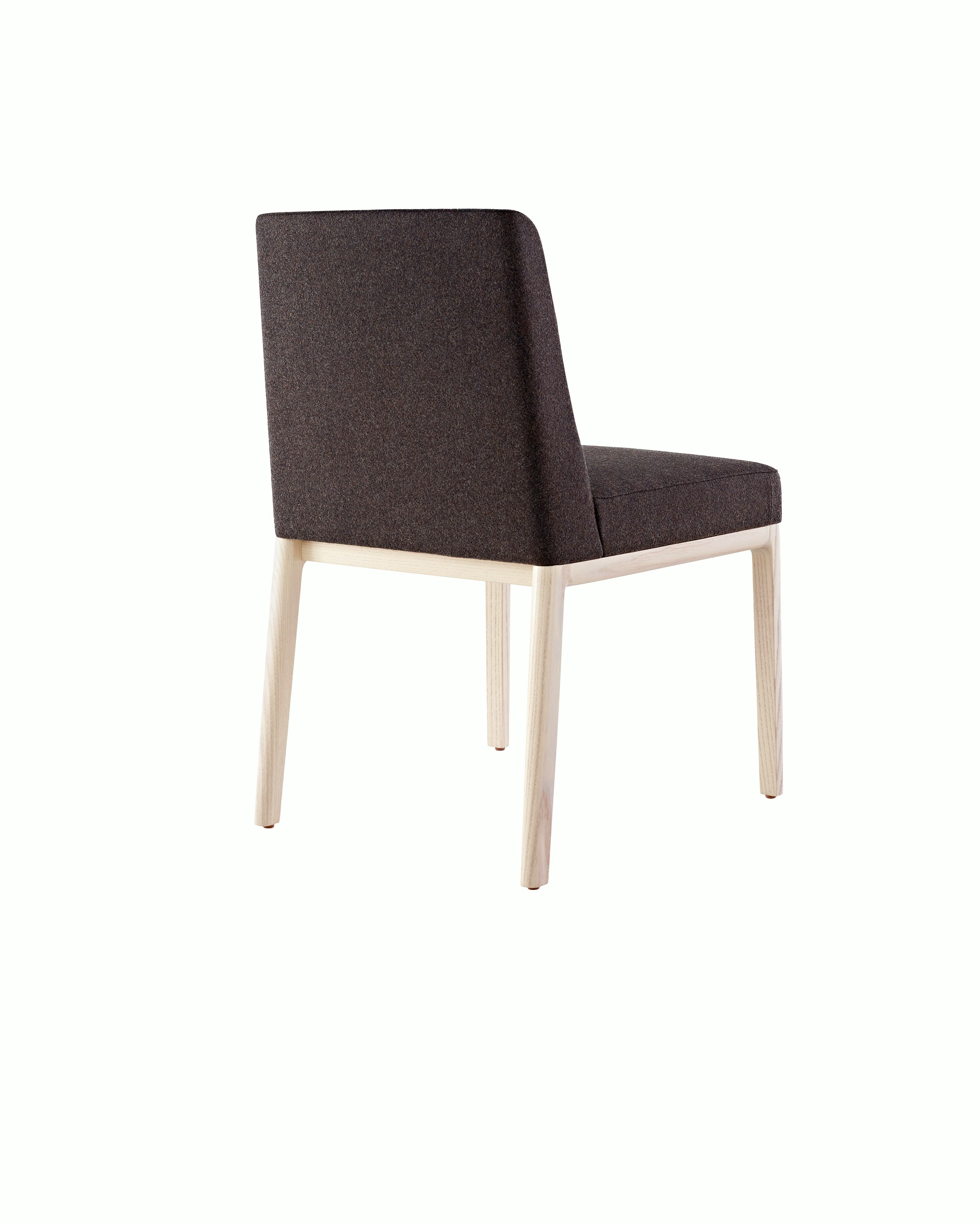 An armless Nessel side chair with black fabric upholstery and a wood frame with a light finish, viewed from behind at an angle.