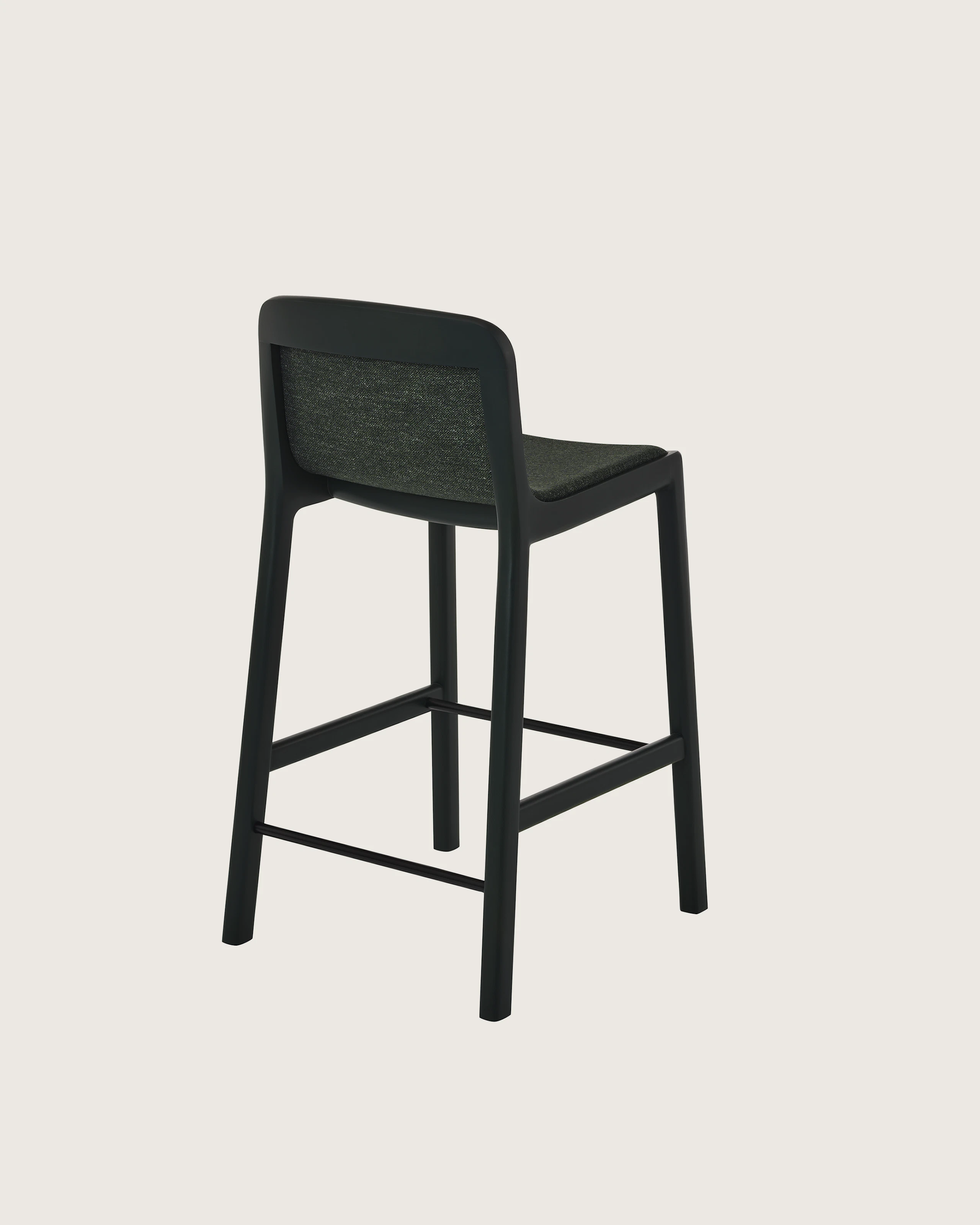 Lijn Stool by Carole Baijings for Geiger in Ivy frame upholstered with Bellano in Black Green, angled back view on a white sweep.