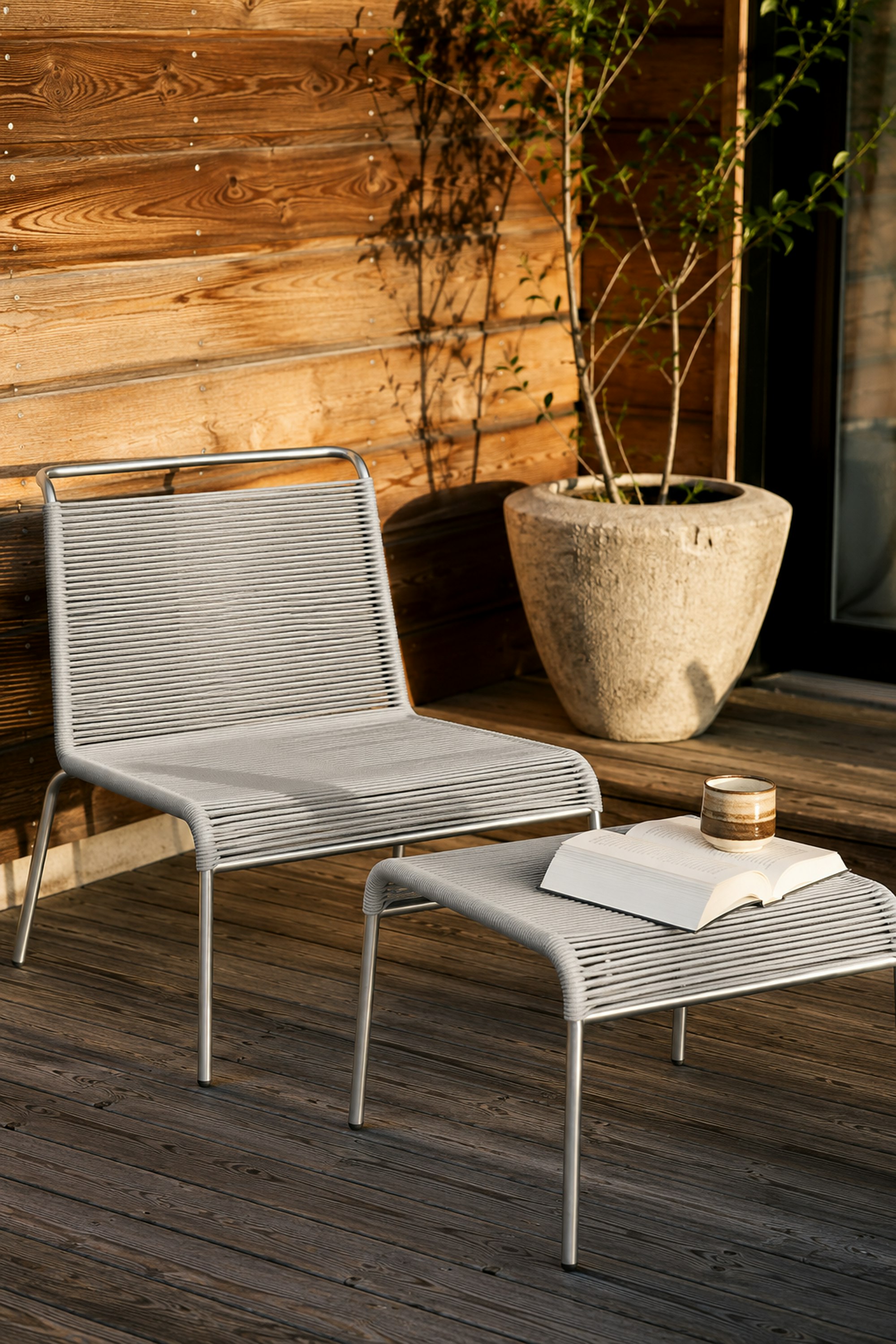 An environmental shot of Teglgaard Outdoor Ottoman in Light Grey.