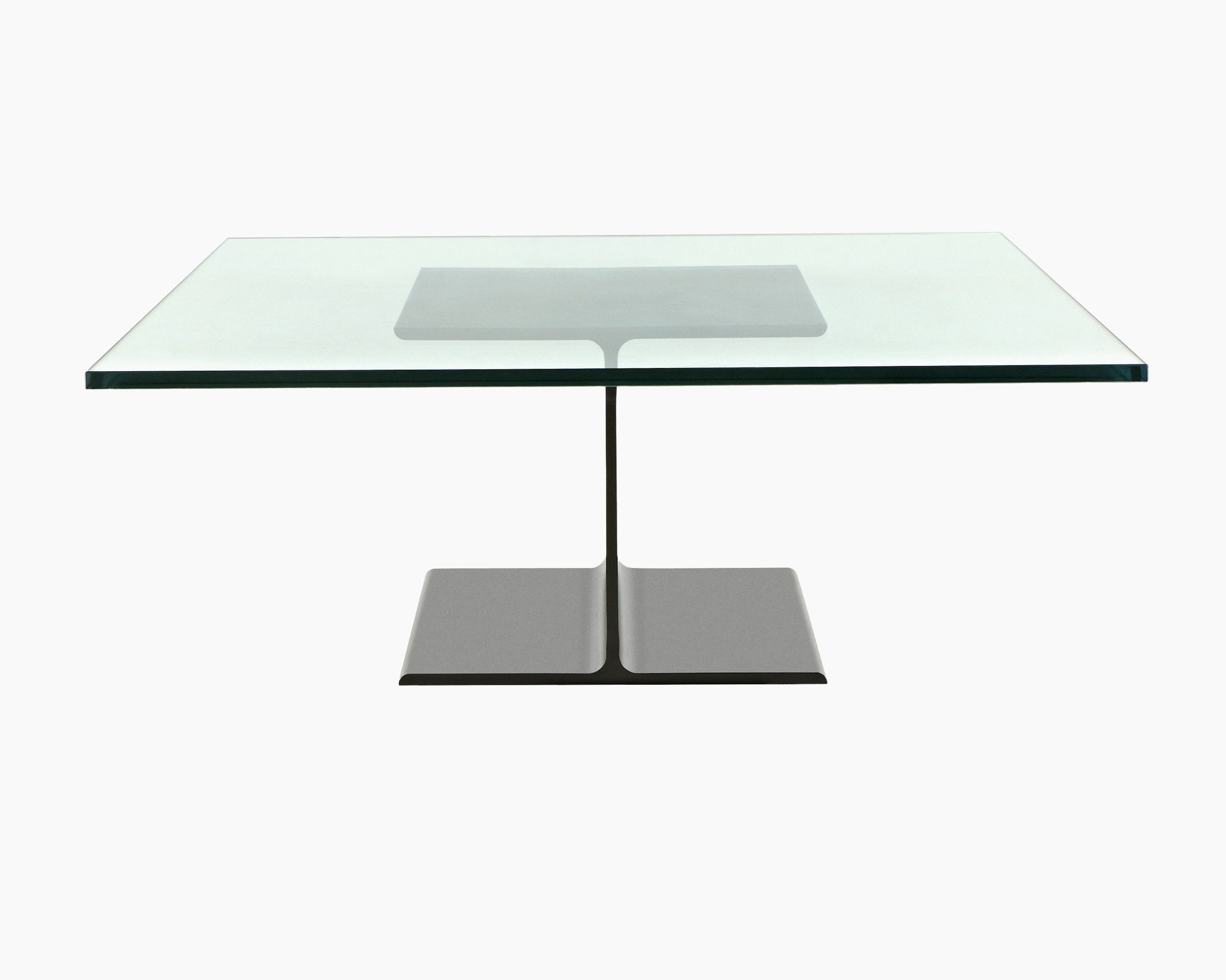 A glass-top I Beam coffee table, with the upper and lower flanges of the cast-aluminum pedestal viewed in profile.