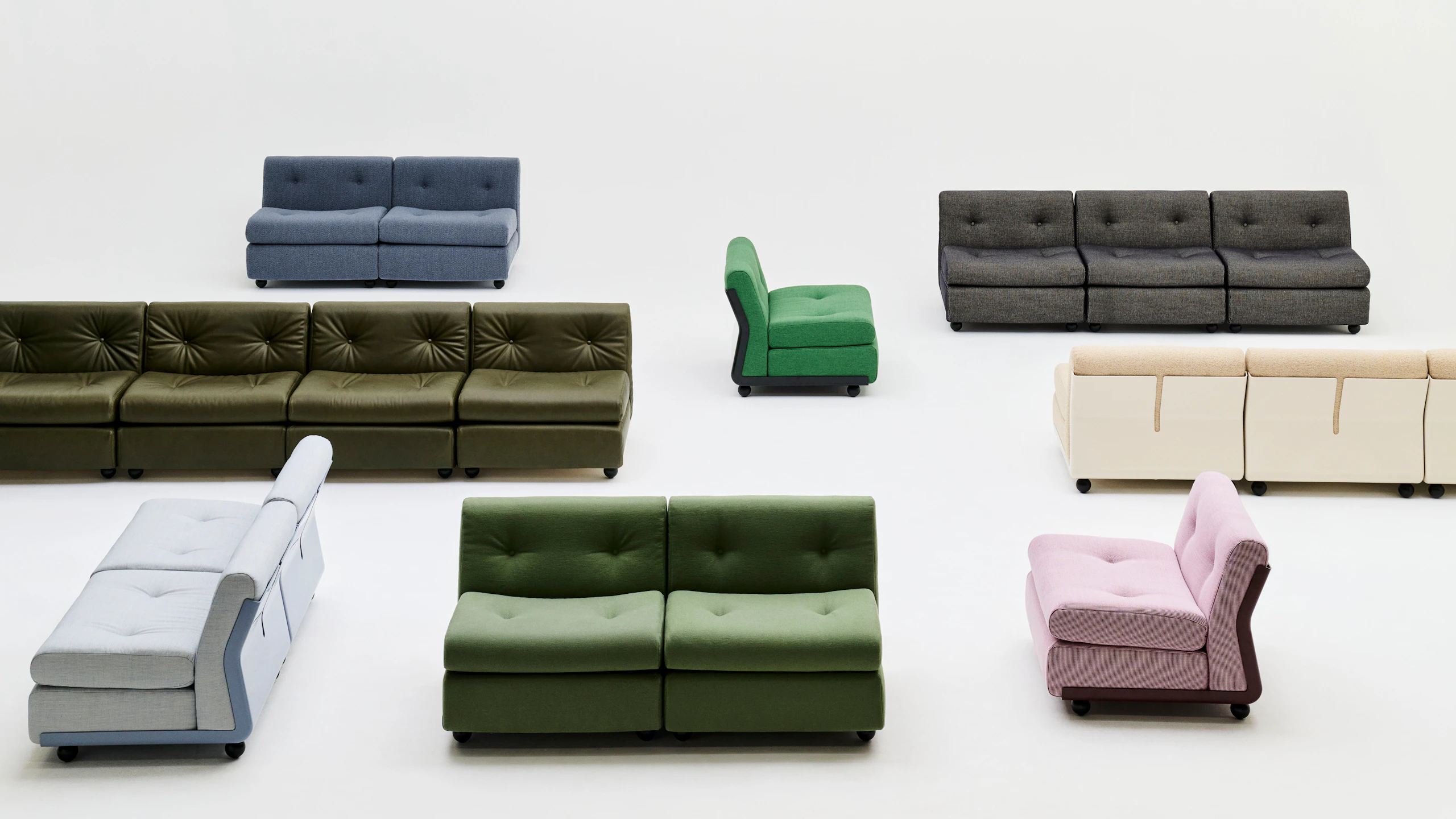 Top-down view of mixed Amanta modules in green, black, blue, pink, and gray, arranged in grid.