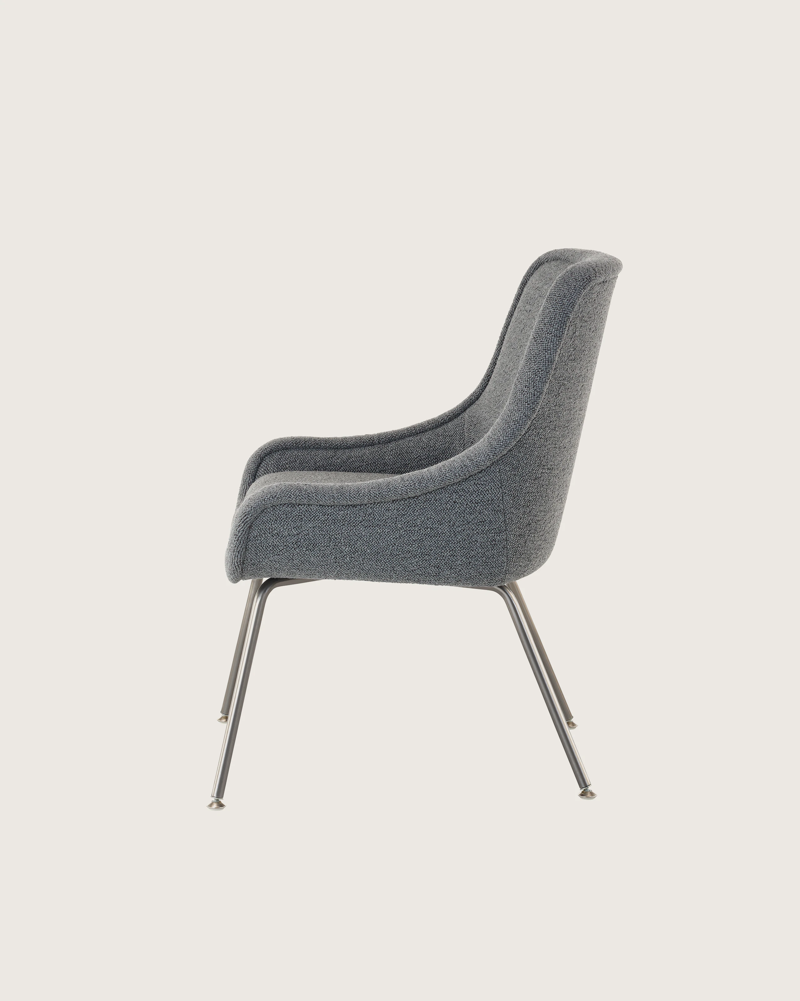 Bumper Armchair with low arms and four legged base, side view.