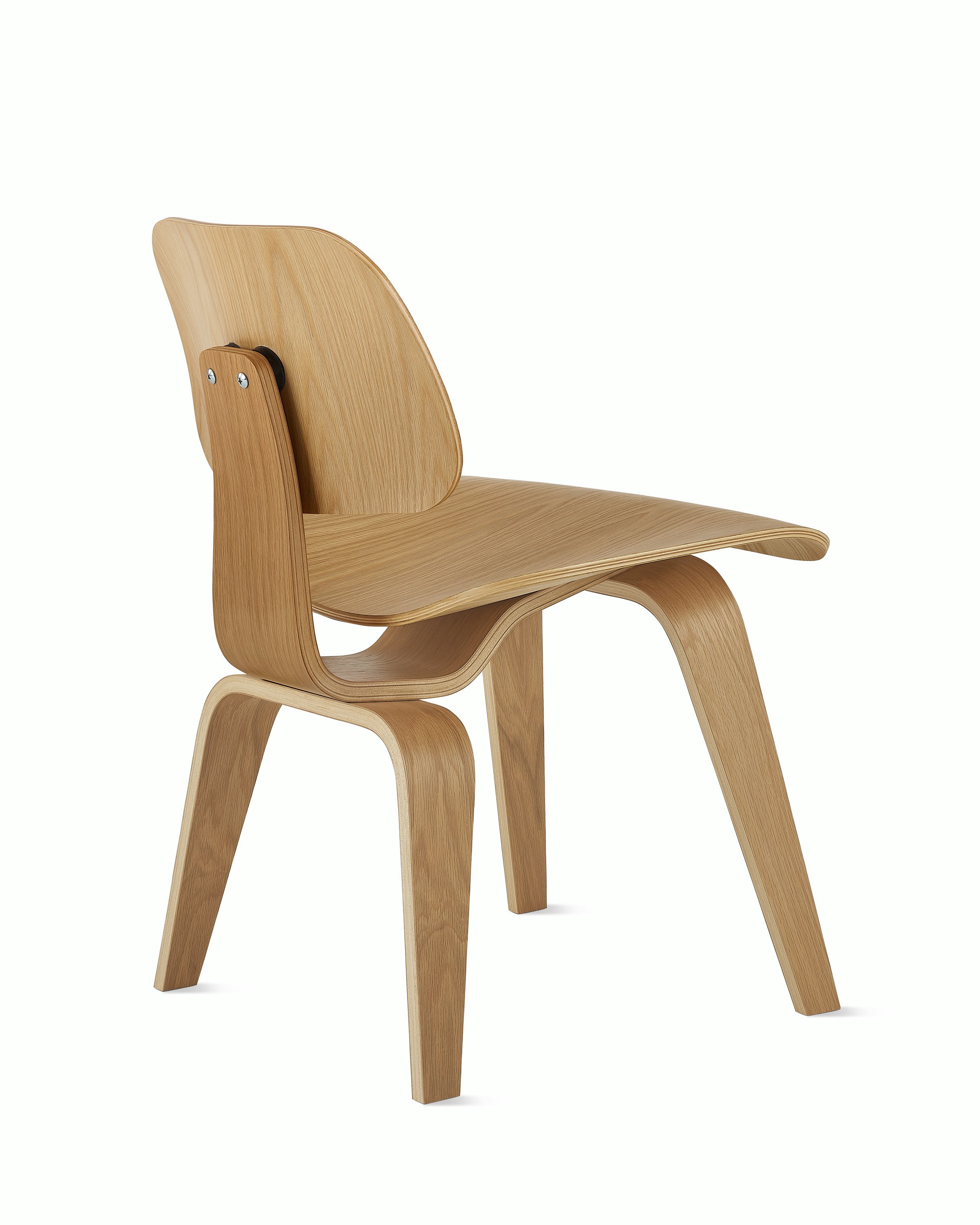 An Eames Molded Plywood Dining Chair in White Oak viewed at an angle