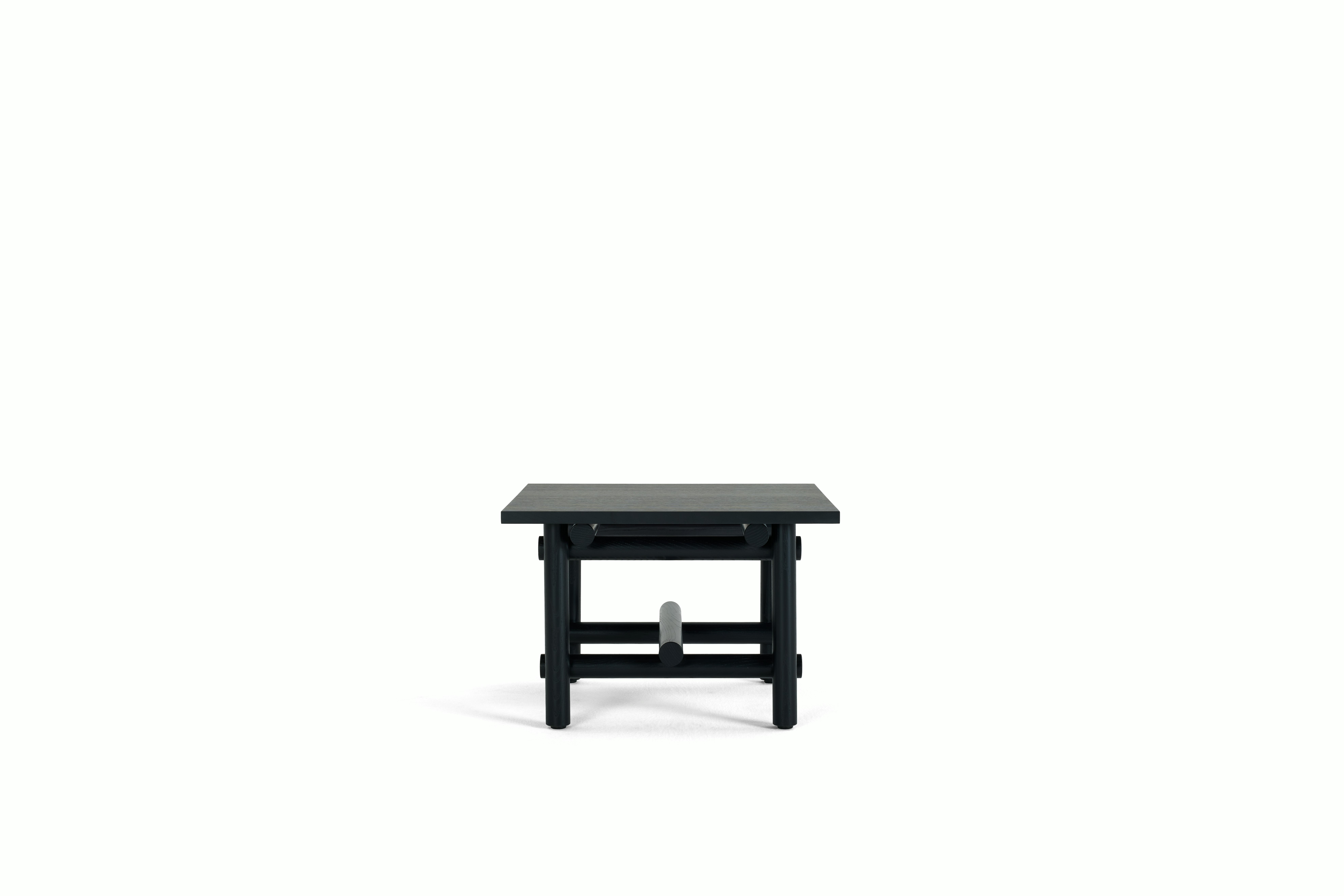 A Muecke Side Table in Ebonized viewed from the side.