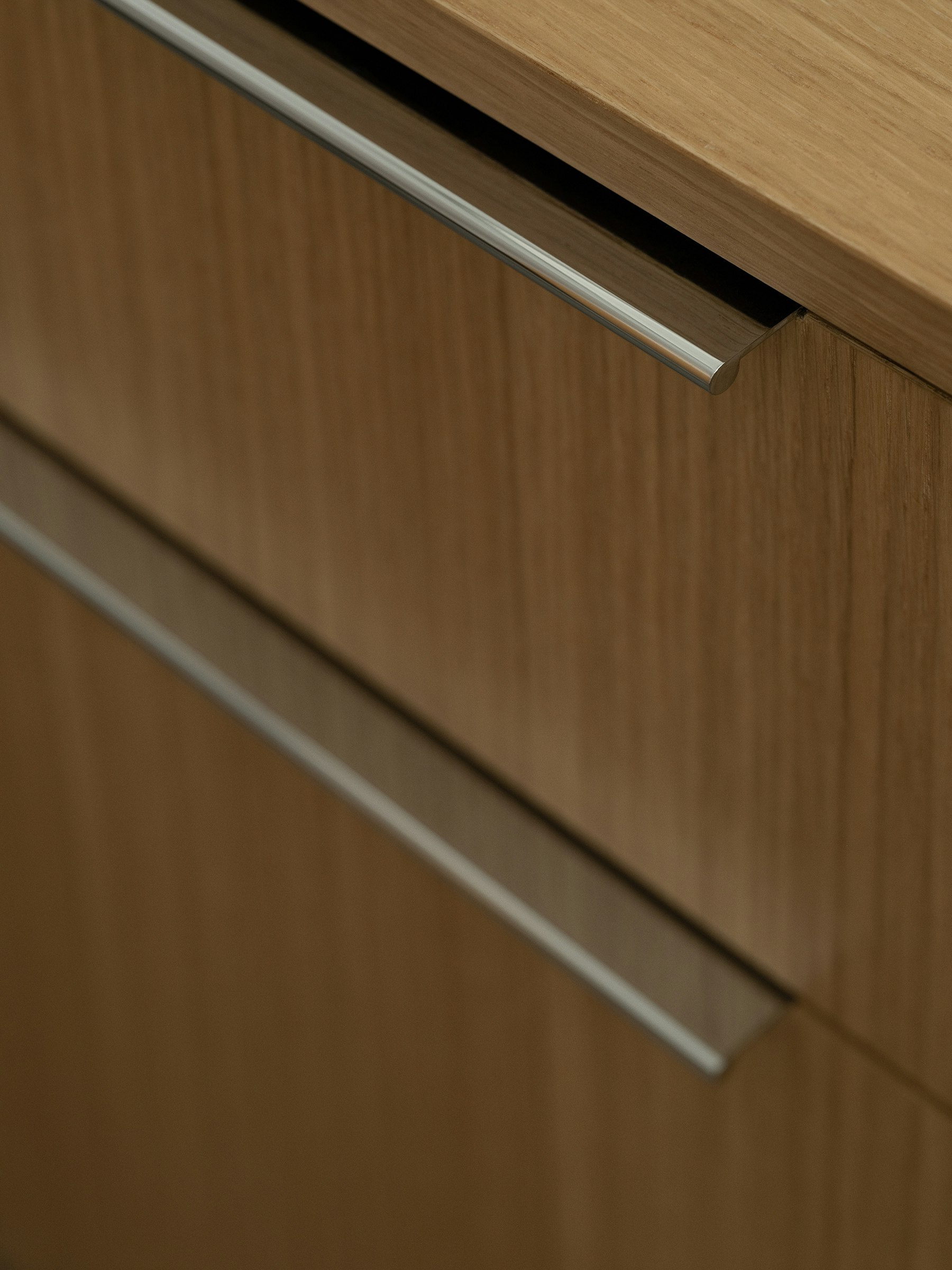 Detail view of Geiger One Open Plan workstation desk drawers and pulls in Natural Rift Cut Oak, viewed from above at an angle.