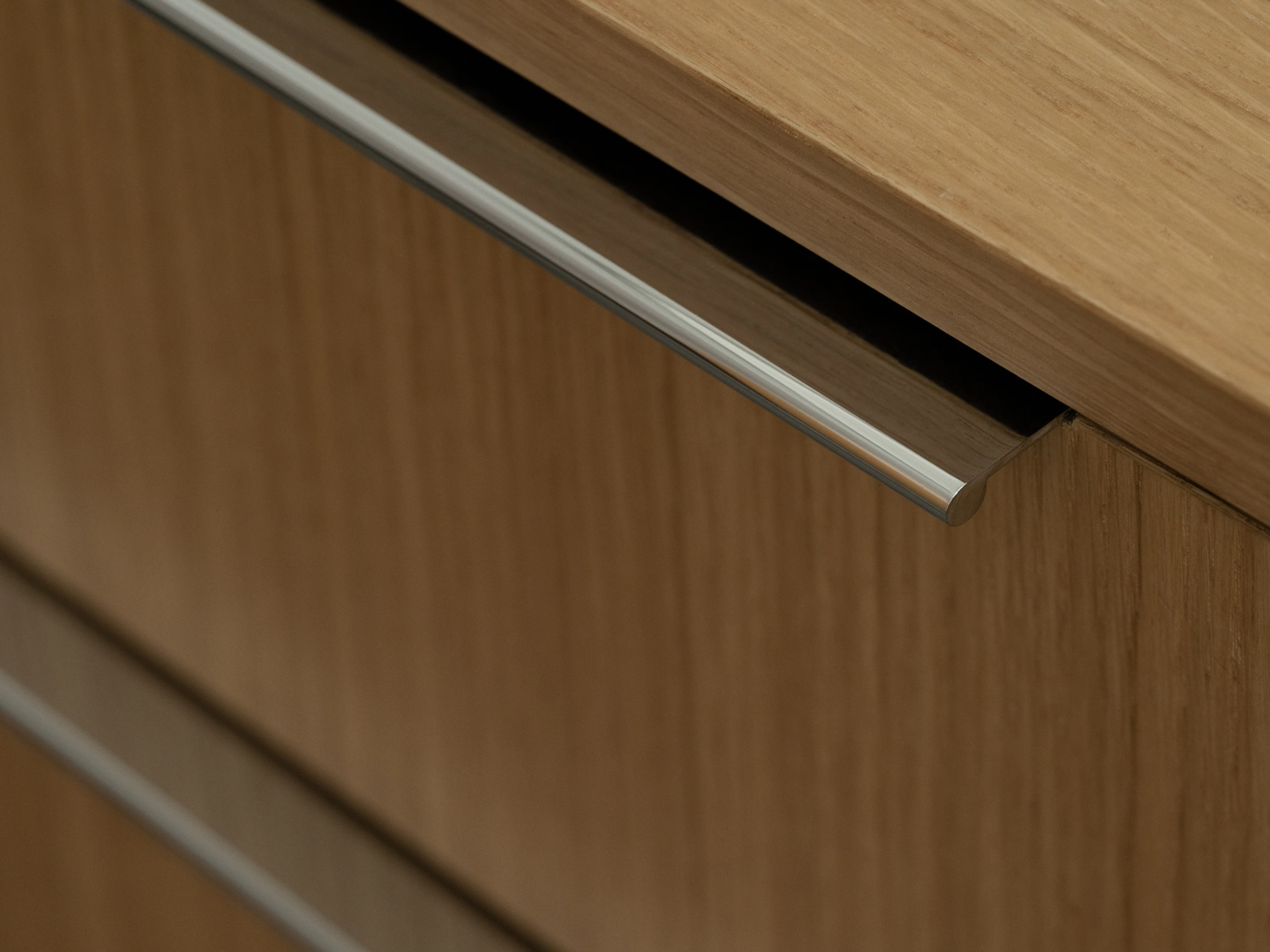 Detail view of Geiger One Open Plan workstation desk drawers and pulls in Natural Rift Cut Oak, viewed from above at an angle.
