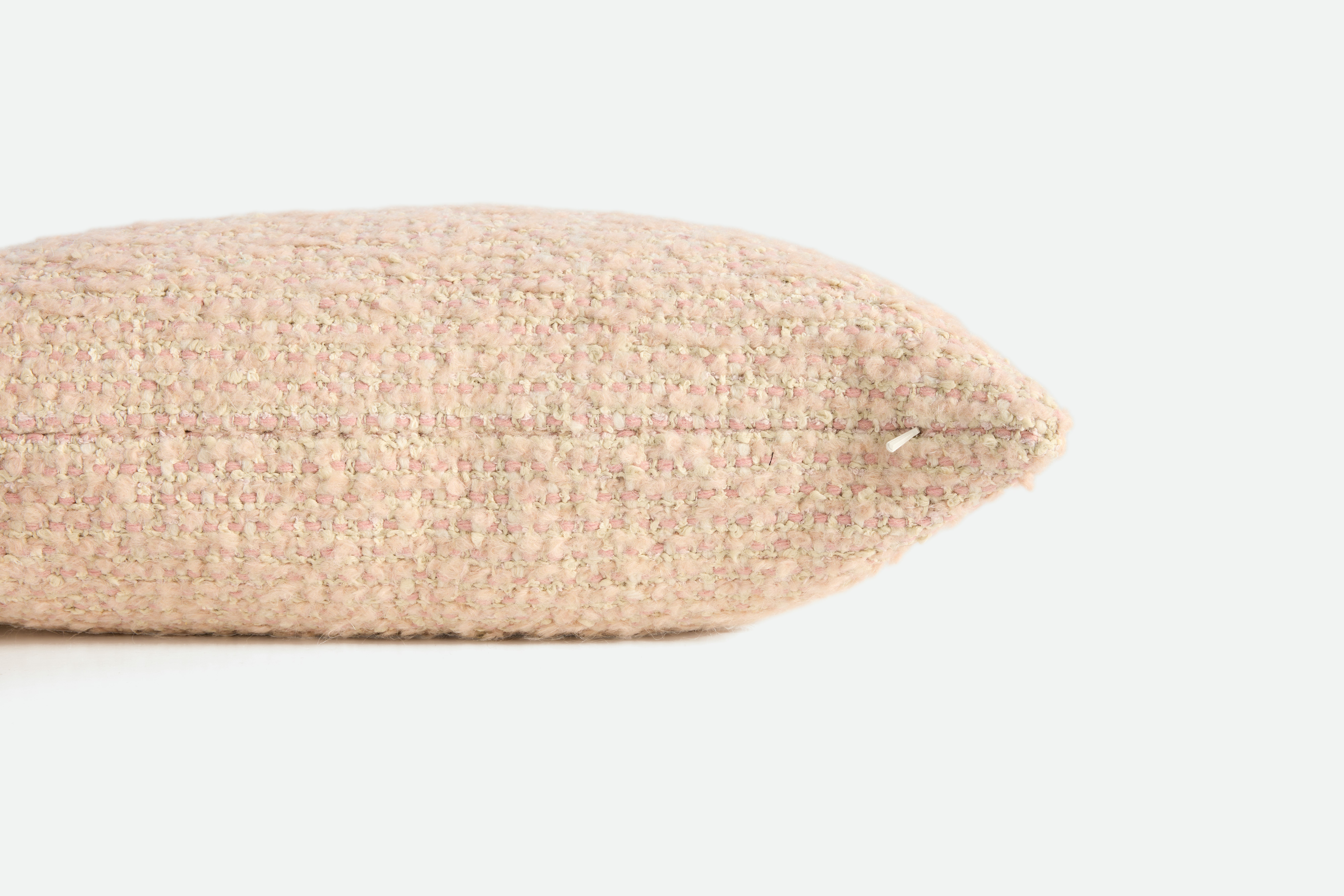 A detailed look at a Holly Hunt Cardigan Pillow in Rose.