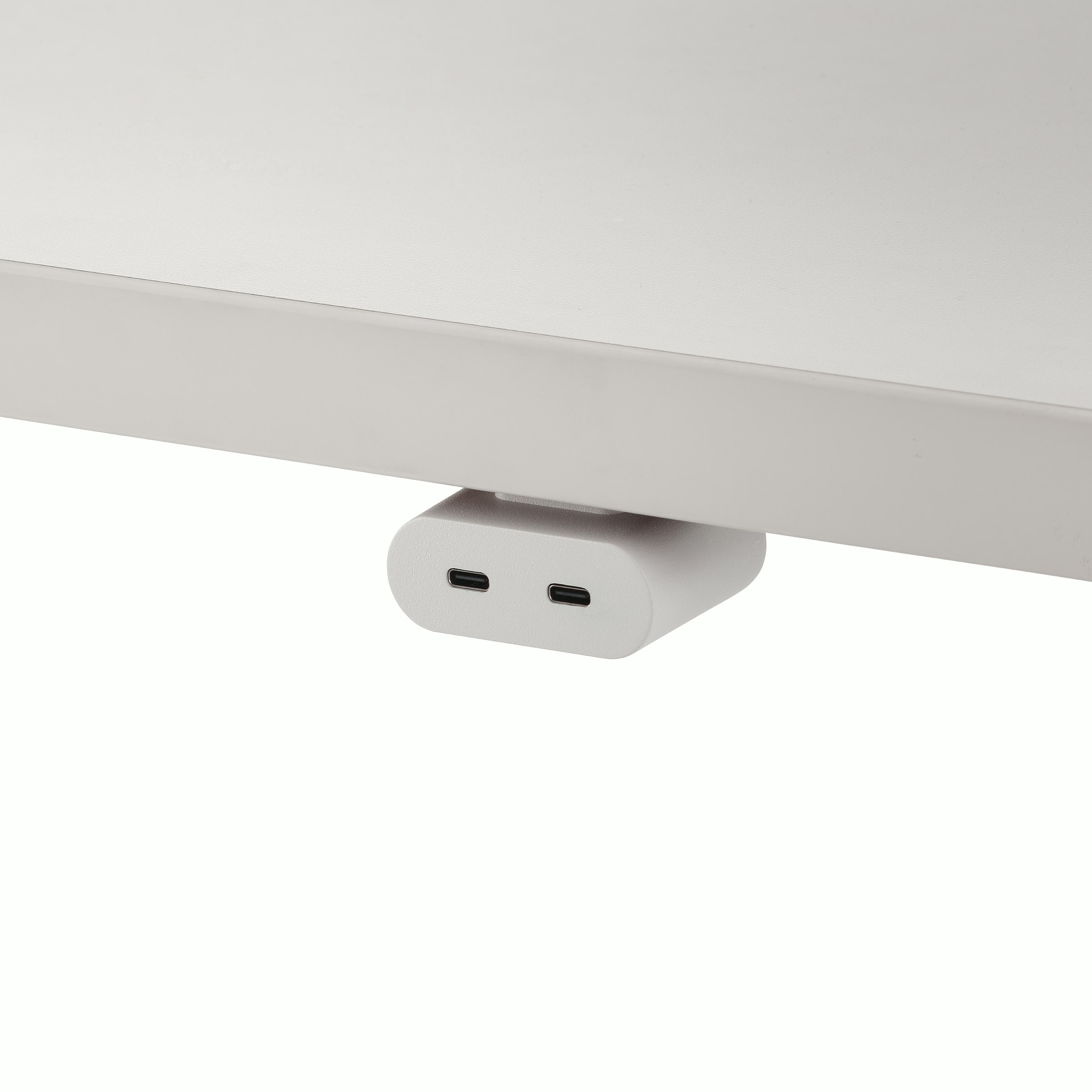 White USB-C power access module that is attached to a white surface.