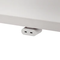 White USB-C power access module that is attached to a white surface.