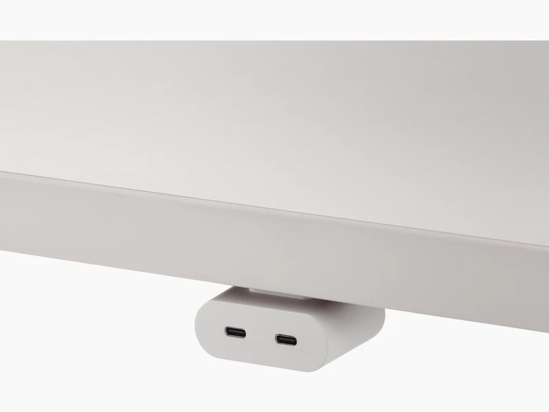 White USB-C power access module that is attached to a white surface.