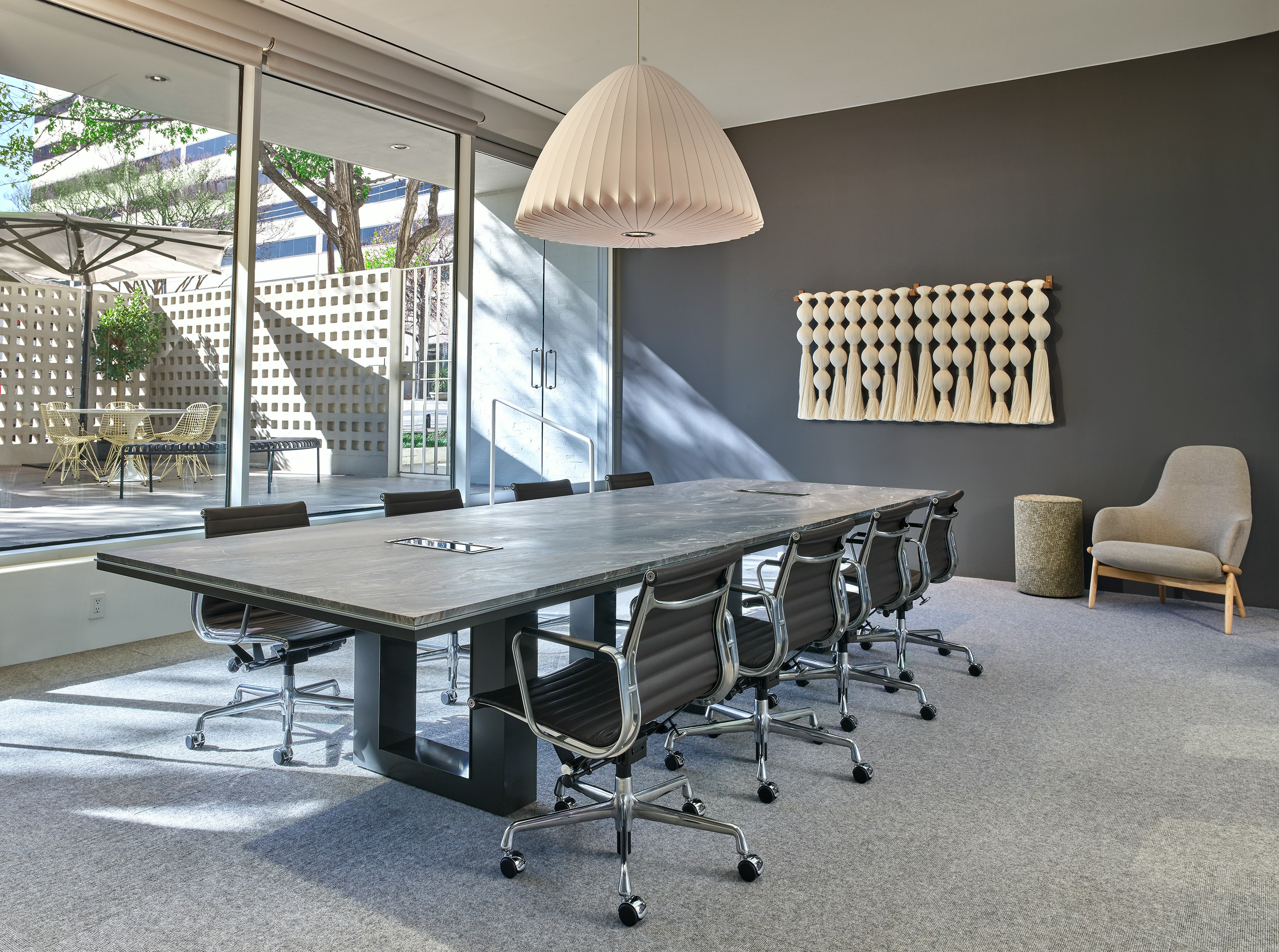 Highline Fifty Conference Table with Eames Aluminum Group Chairs in a conference room setting viewed from an angle.