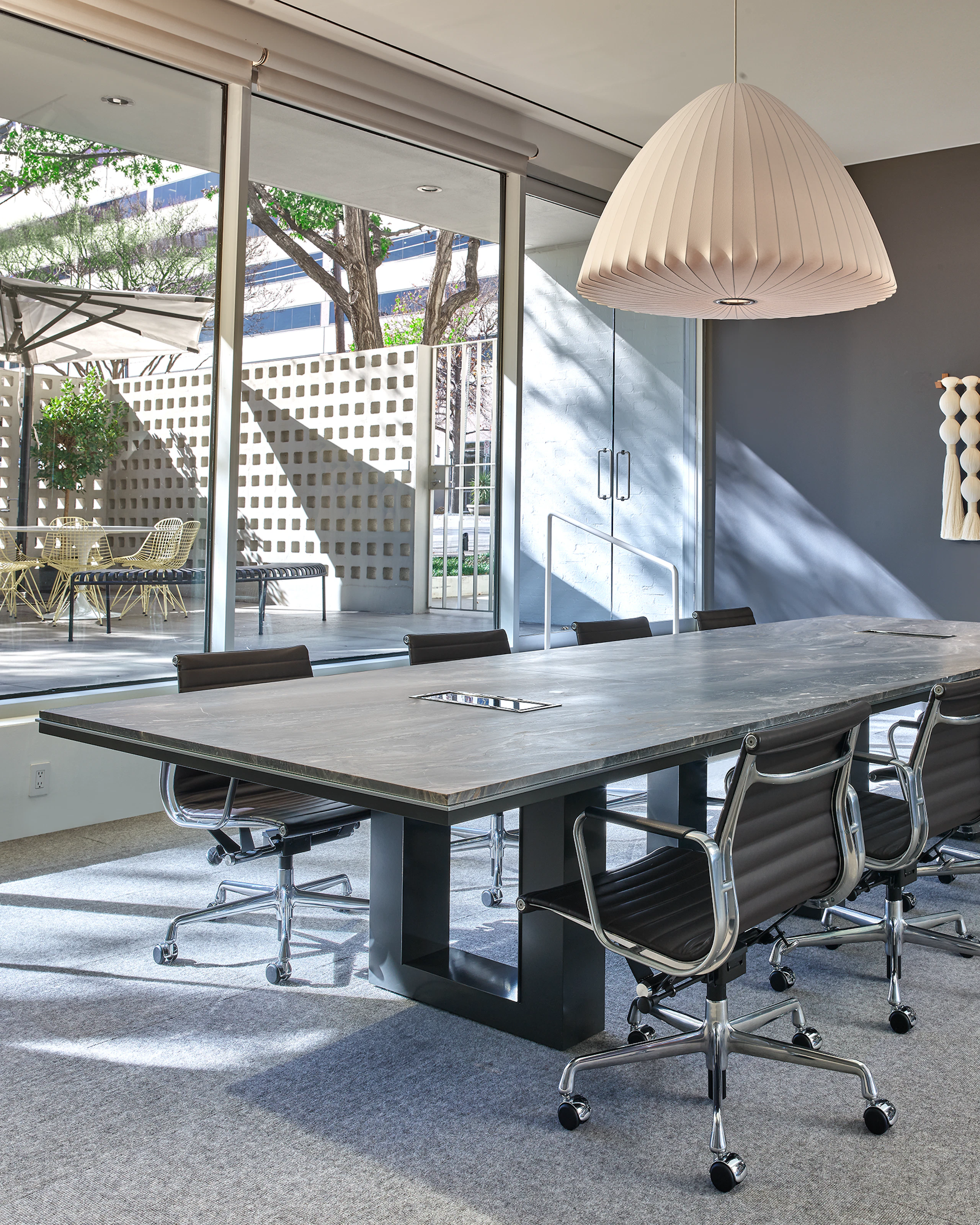 Highline Fifty Conference Table with Eames Aluminum Group Chairs in a conference room setting viewed from an angle.