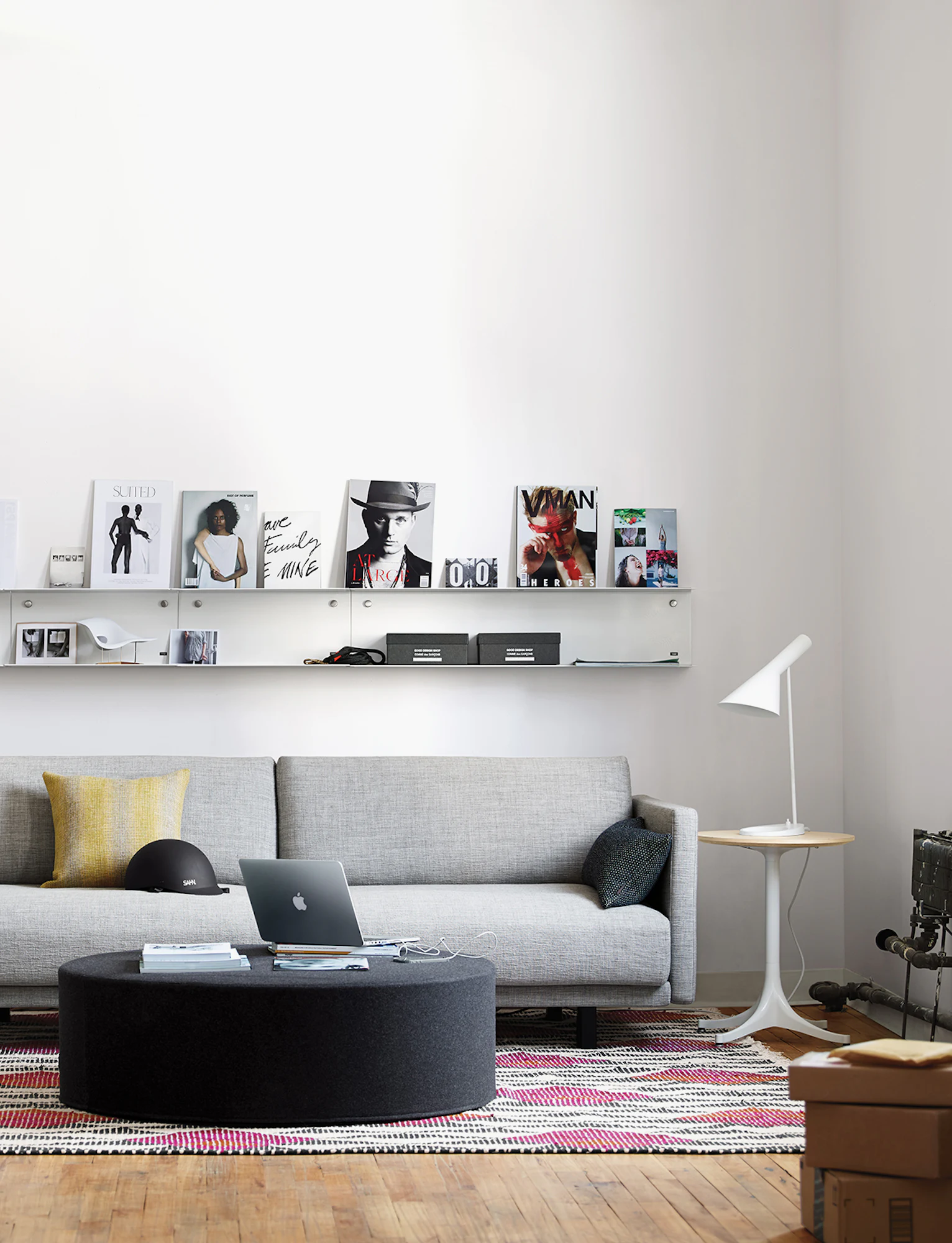 Grey and dark grey drum poufs used as seating in a living room