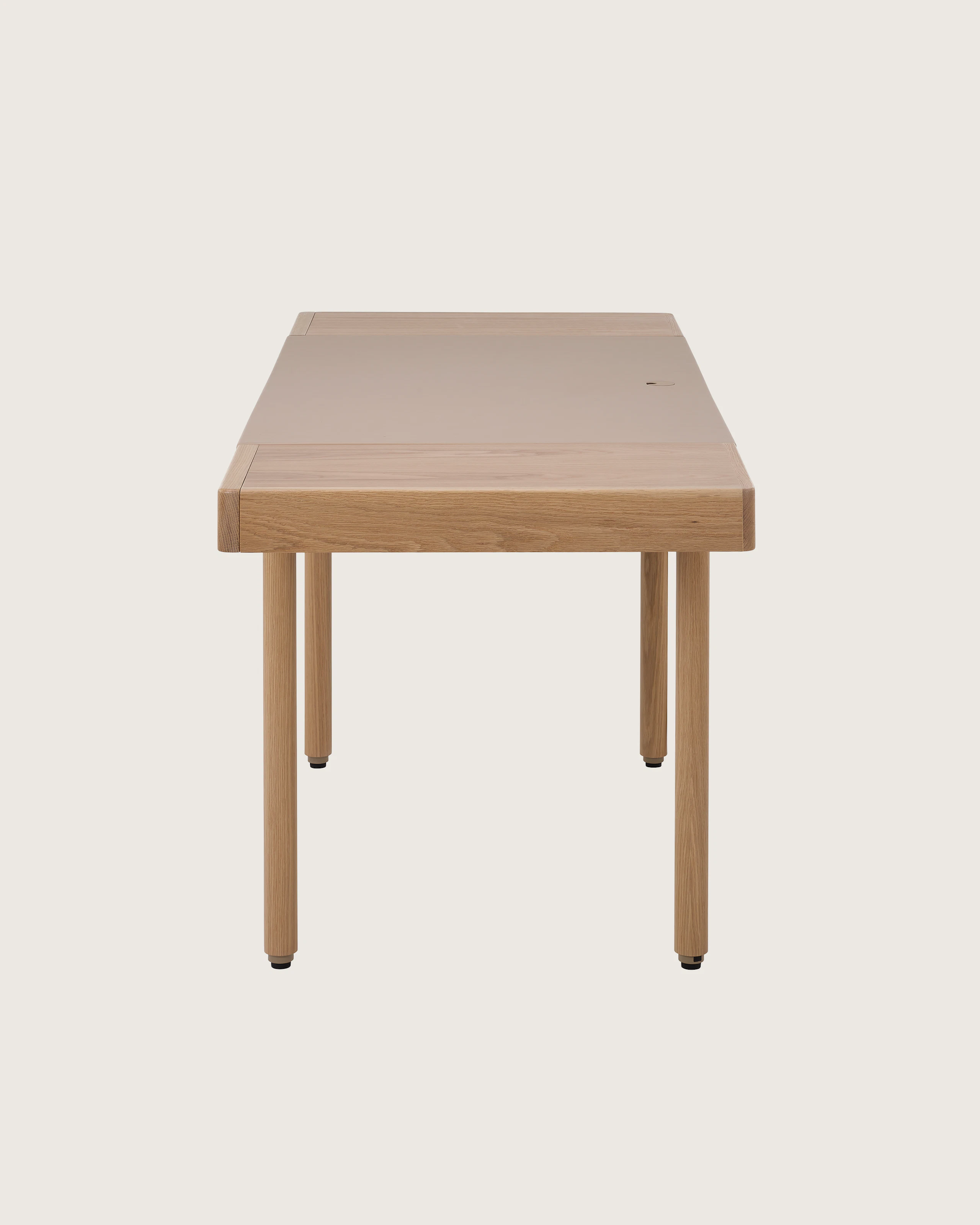 New Canaan Leatherwrap Sit-to-Stand Desk in Oak and Champagne Leather, two drawers, side view.
