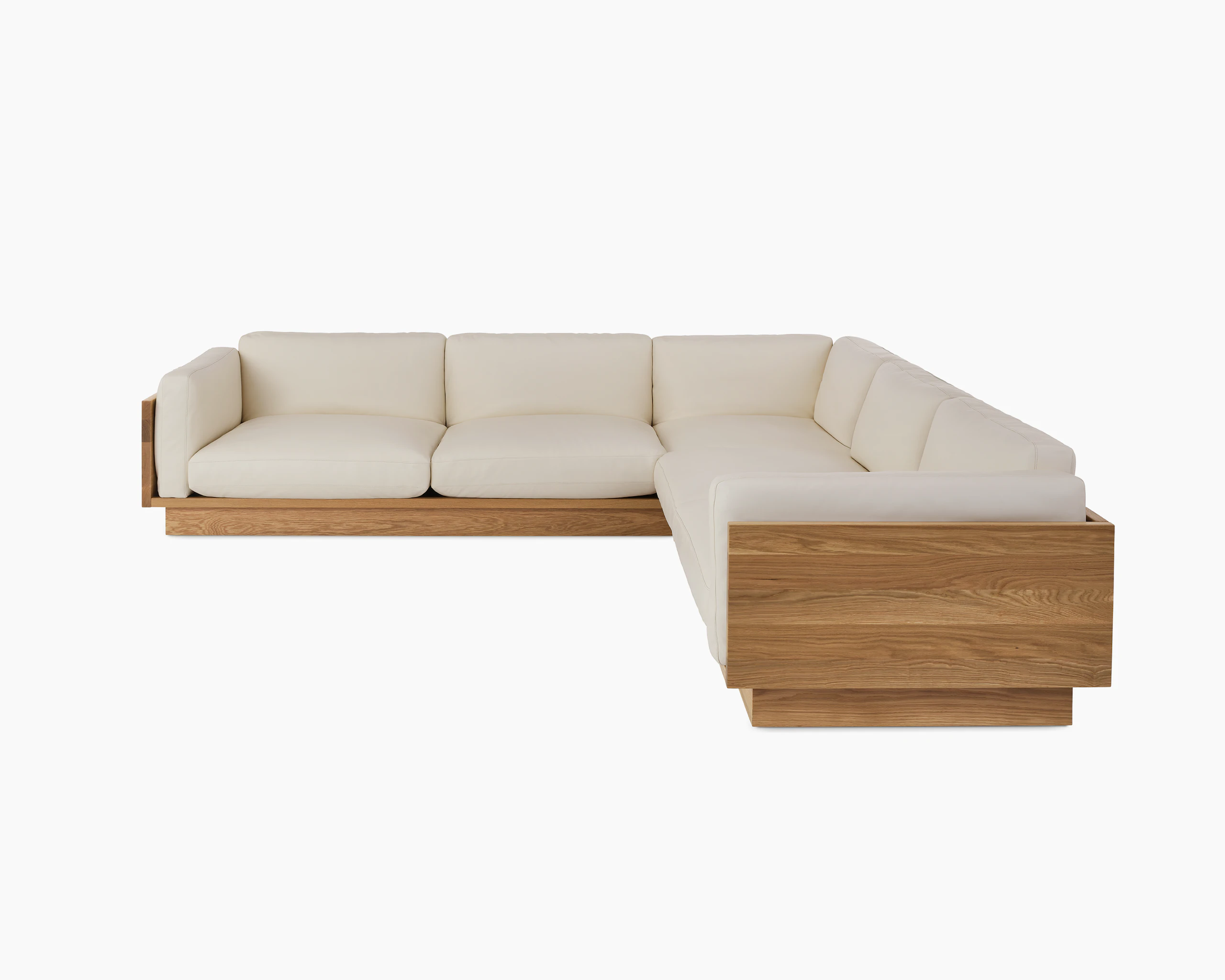 Pawson Drift Sectional Sofa with white leather upholstery and white oak base.