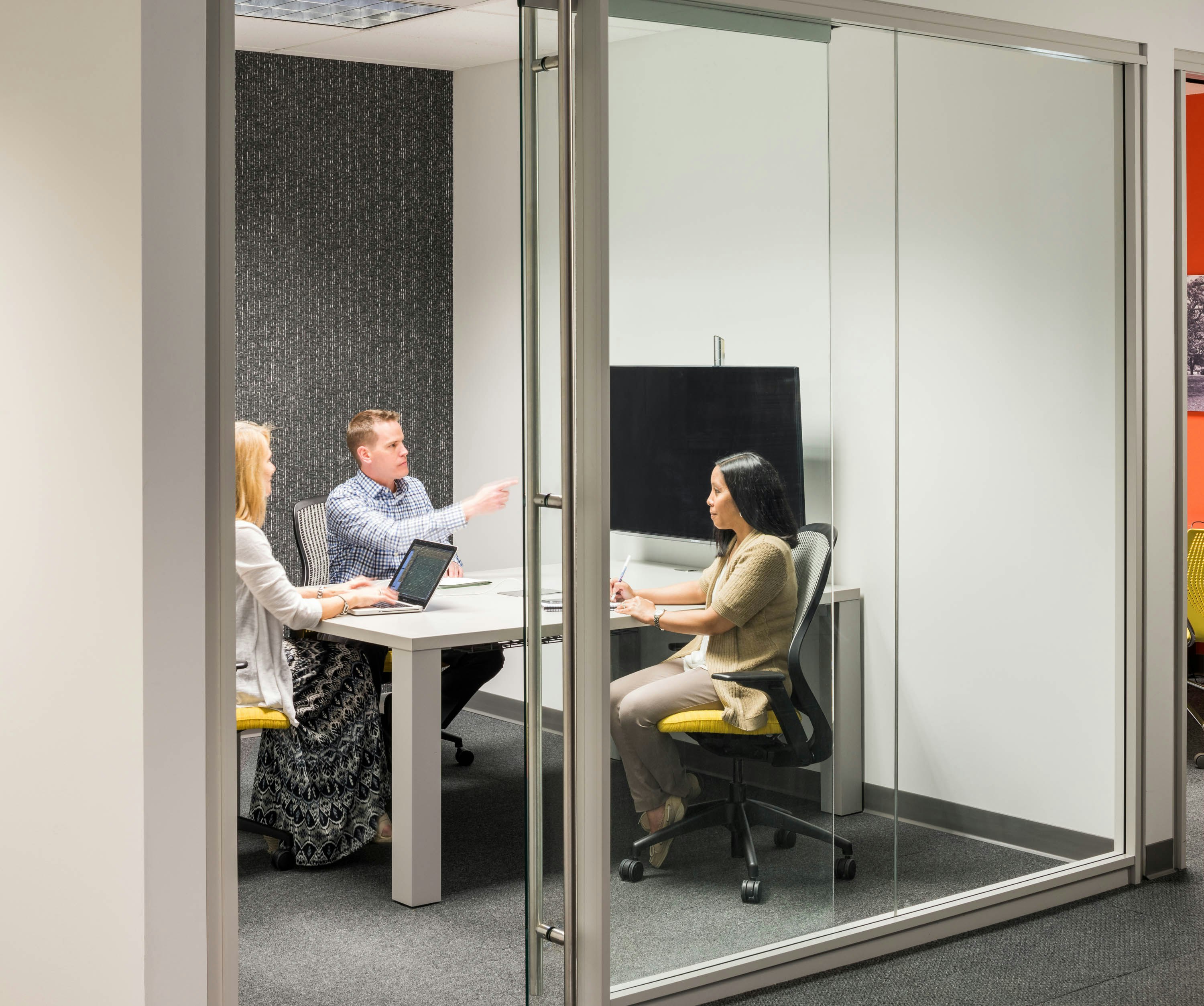 Knoll Reff Profiles meeting table and media enclave with grey and yellow ReGeneration ergonomic chairs