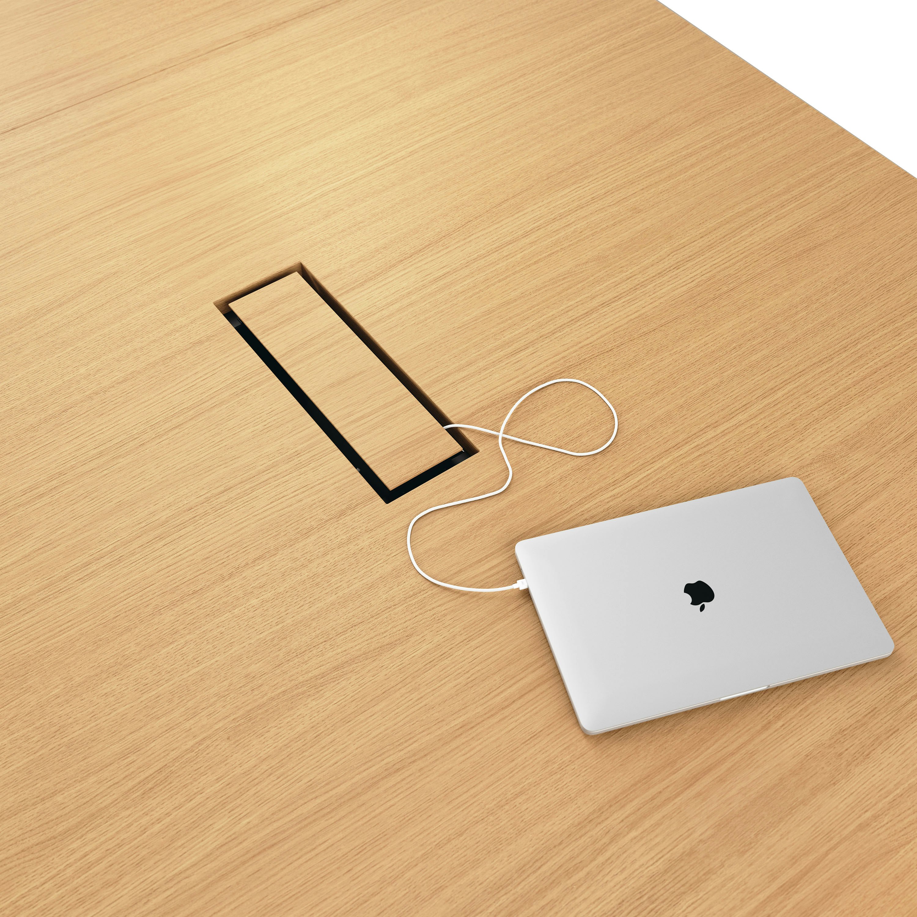 Detail shot of closed tabletop power access on JD Conference Table in Natural Rift Cut Oak.