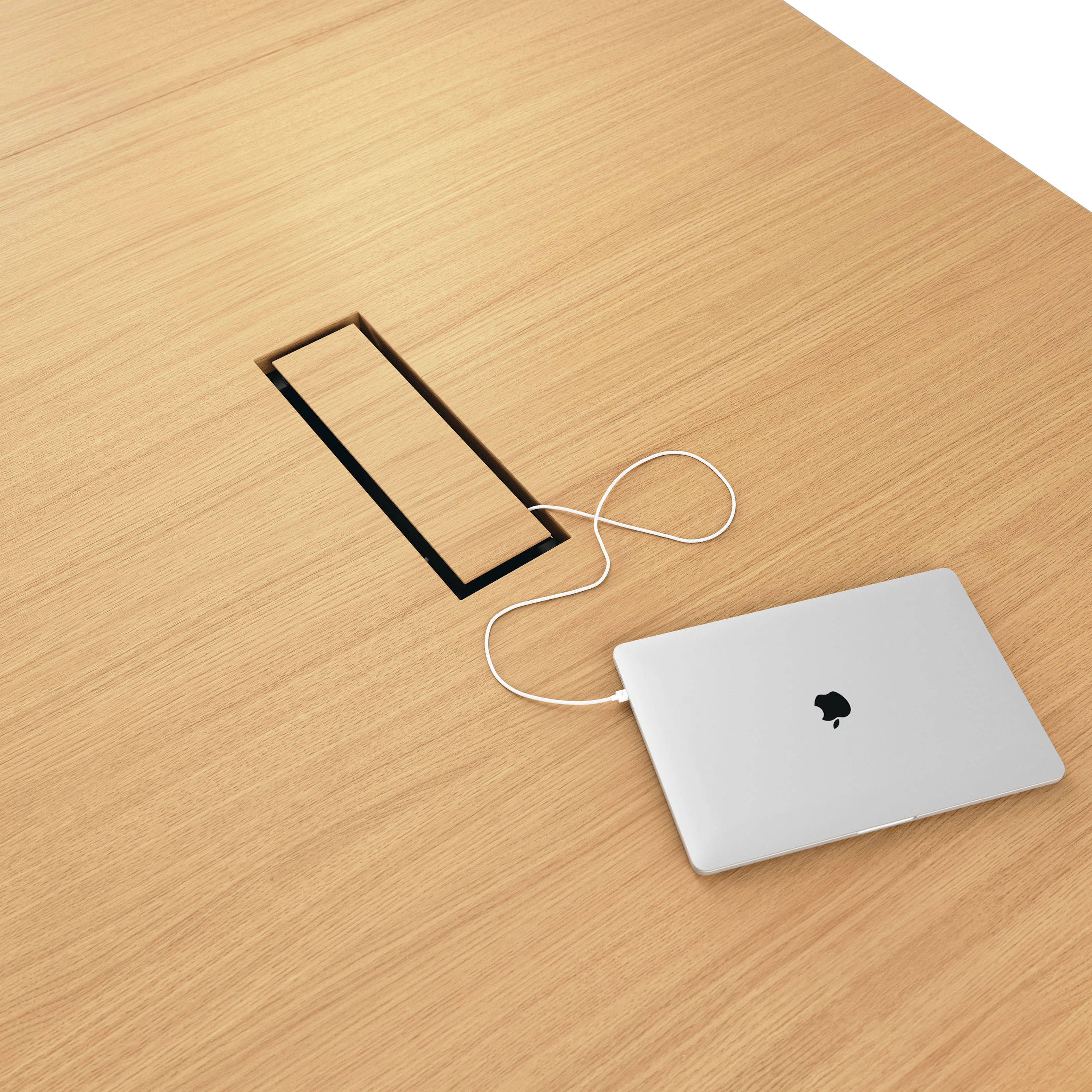 Detail shot of closed tabletop power access on JD Conference Table in Natural Rift Cut Oak.