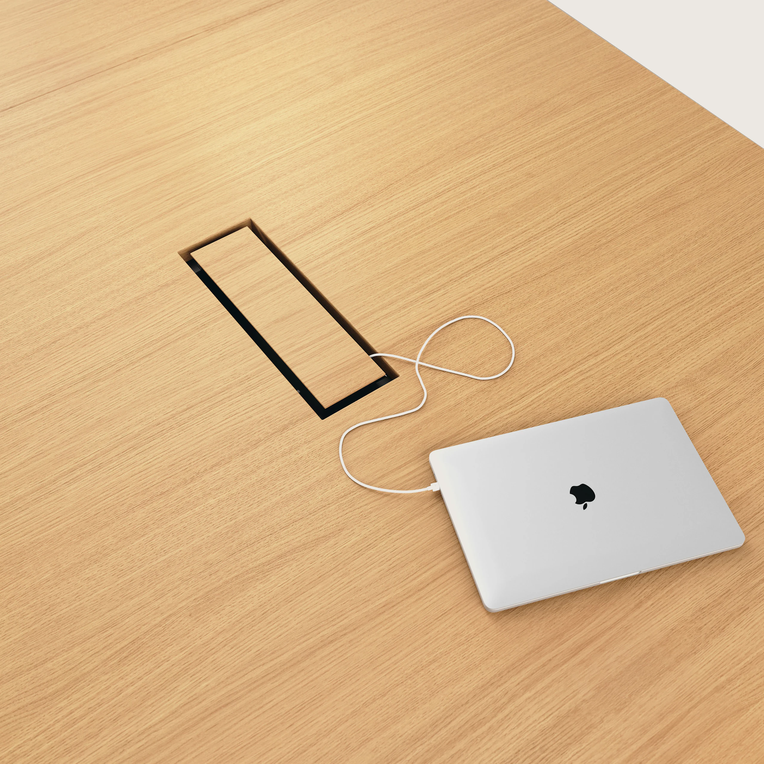 Detail shot of closed tabletop power access on JD Conference Table in Natural Rift Cut Oak.