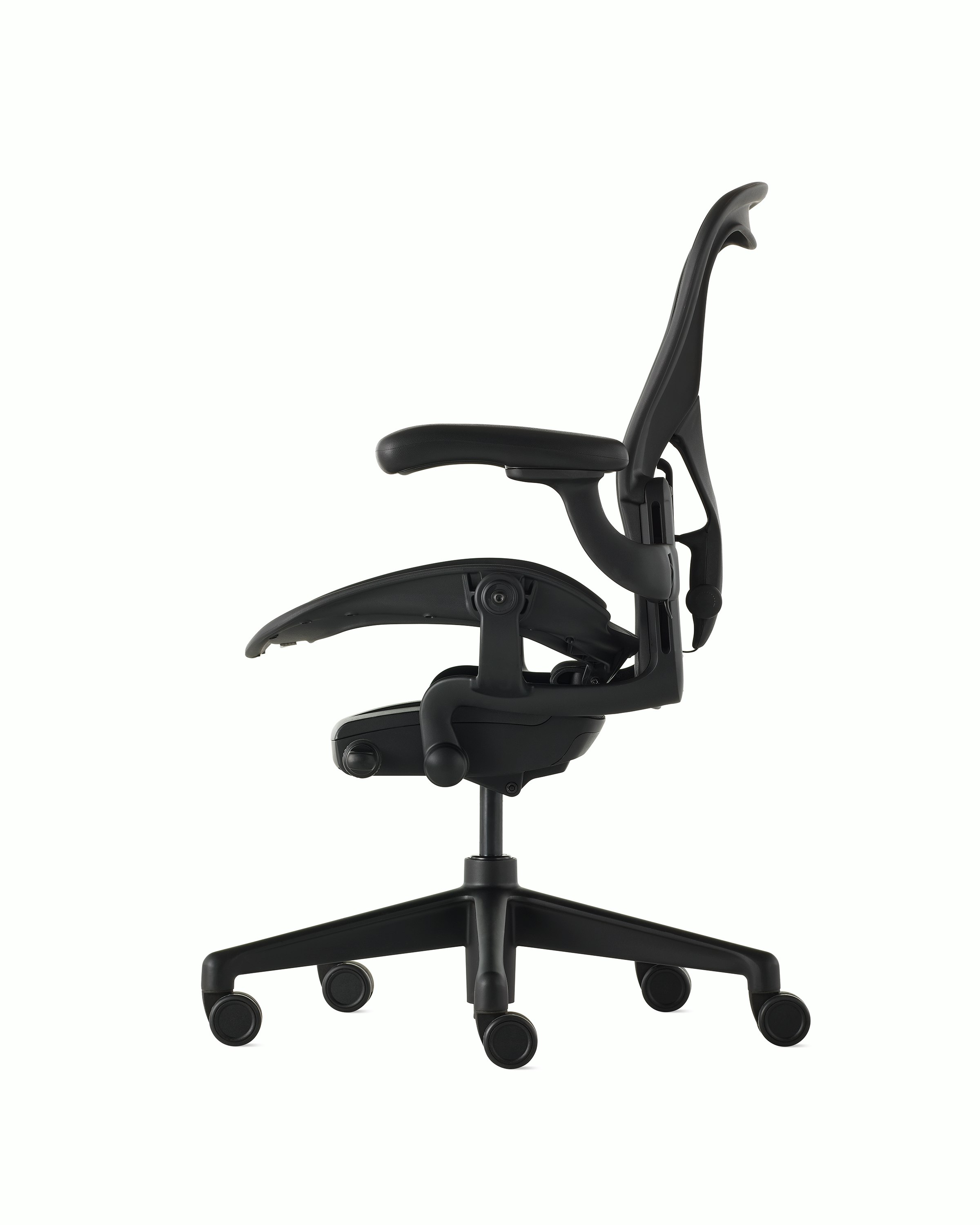 Black matte Aeron Chair on a white background with a 5-star base and ergonomic back support, viewed from the side.