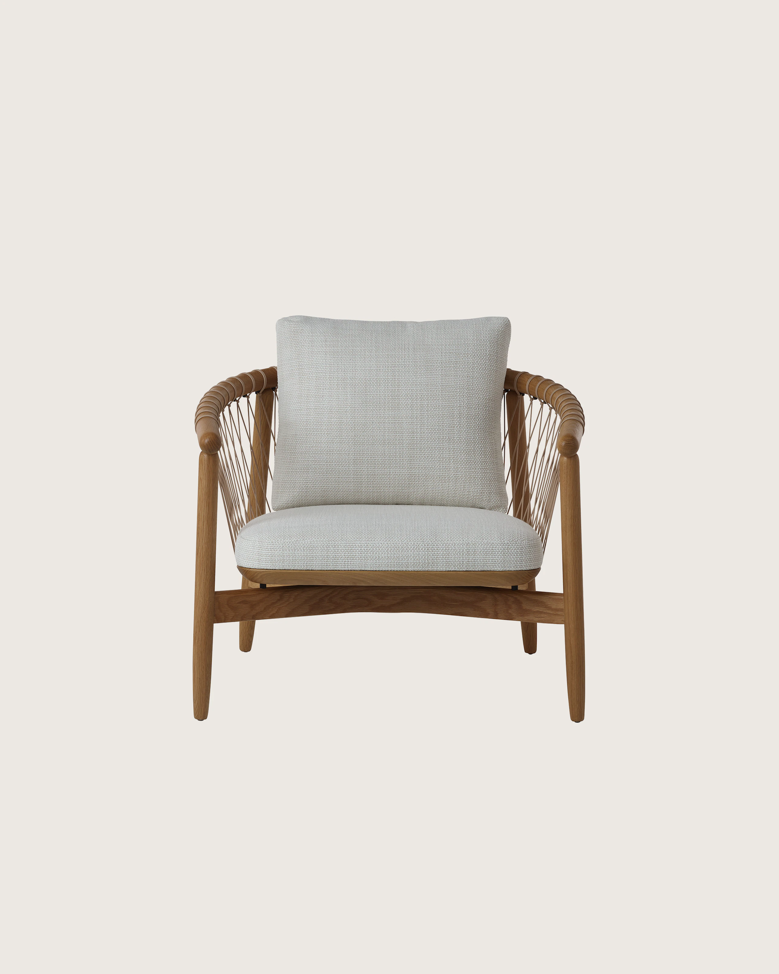 Crosshatch Lounge Chair by EOOS for Geiger in Natural Oak with Capri in Show upholstery, front view on a white sweep.