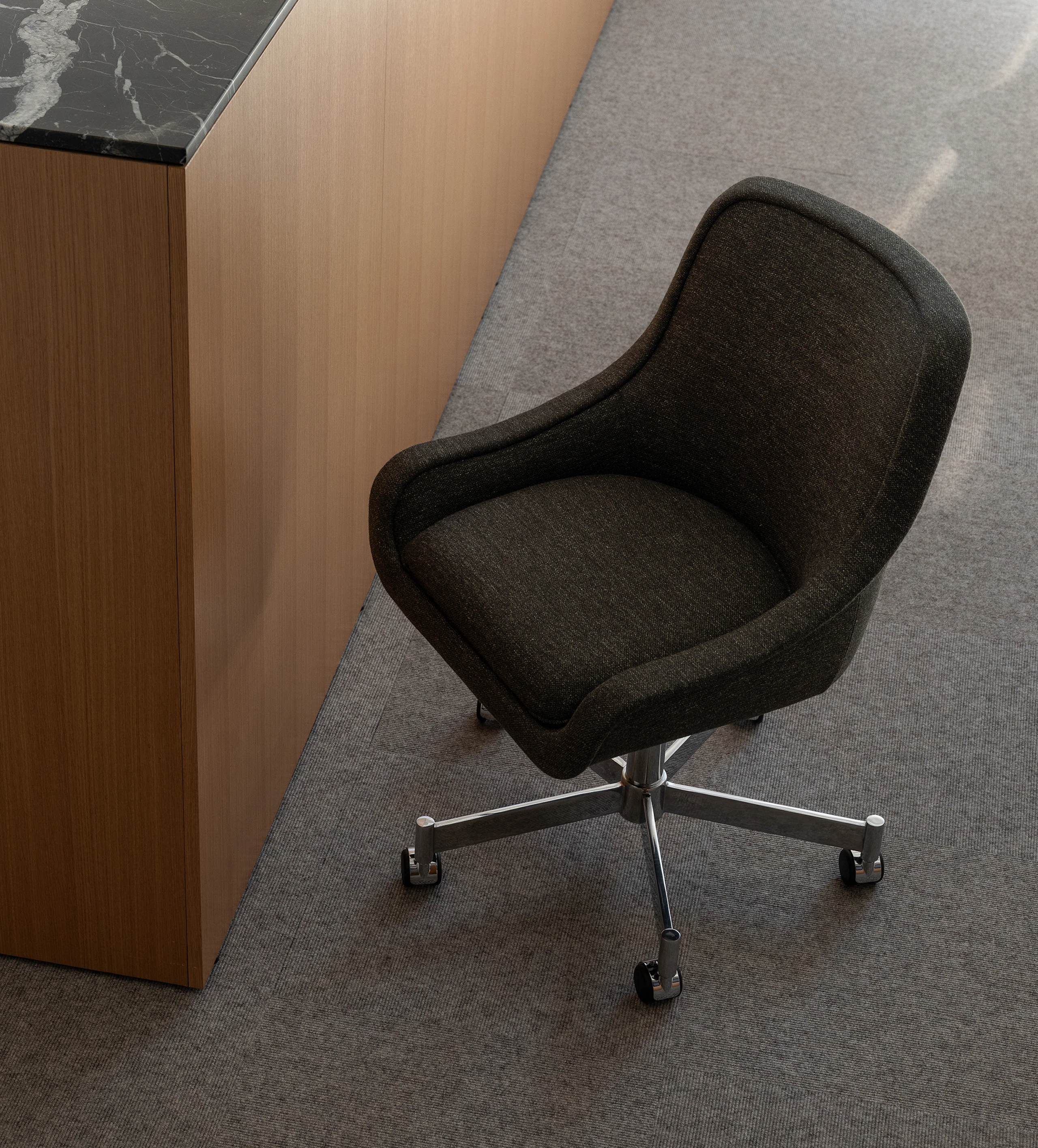 Bumper Conference Chair with low arms upholstered with Bellano in Black Green.