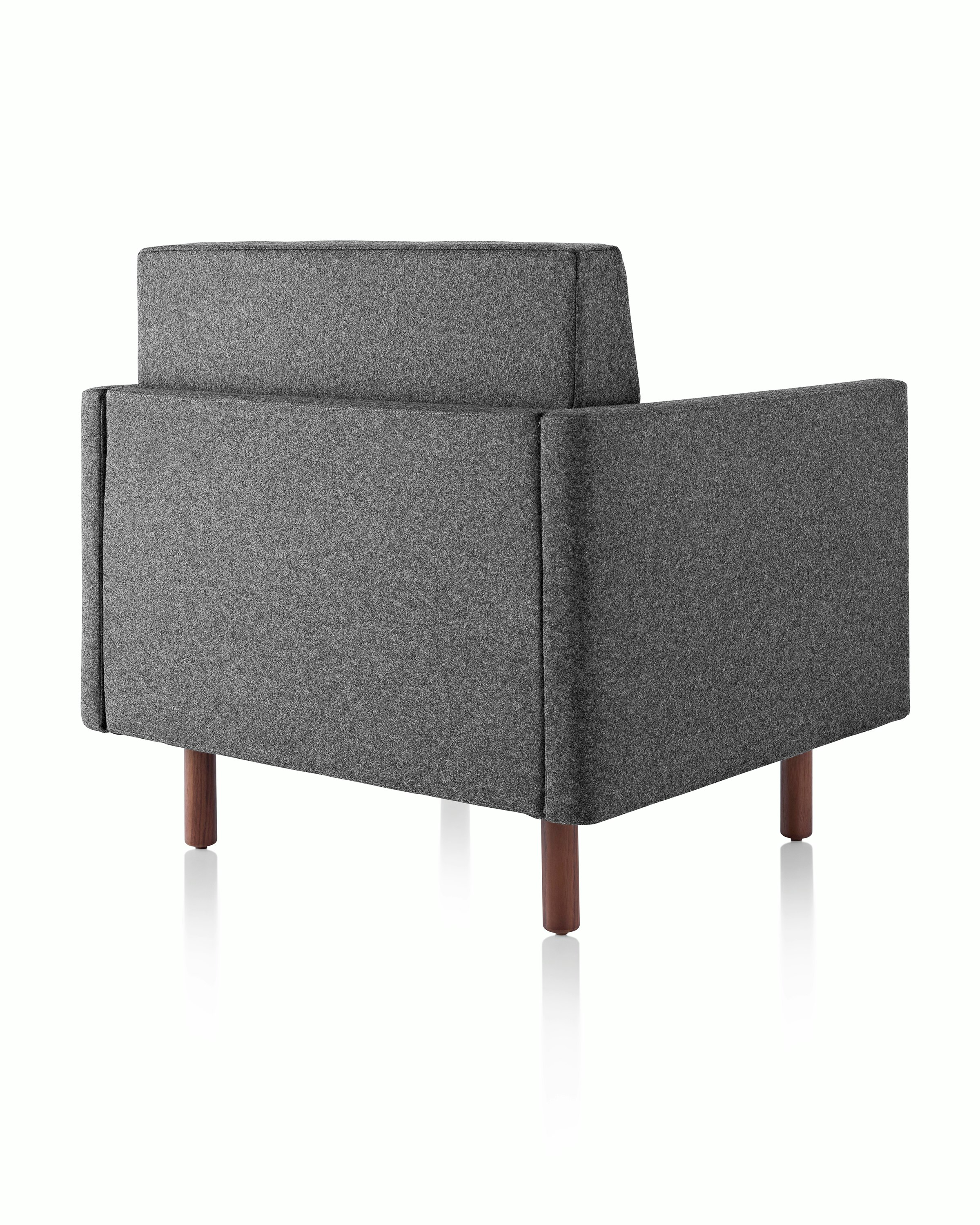 A Tuxedo Classic club chair upholstered in dark gray fabric, viewed from behind at an angle.