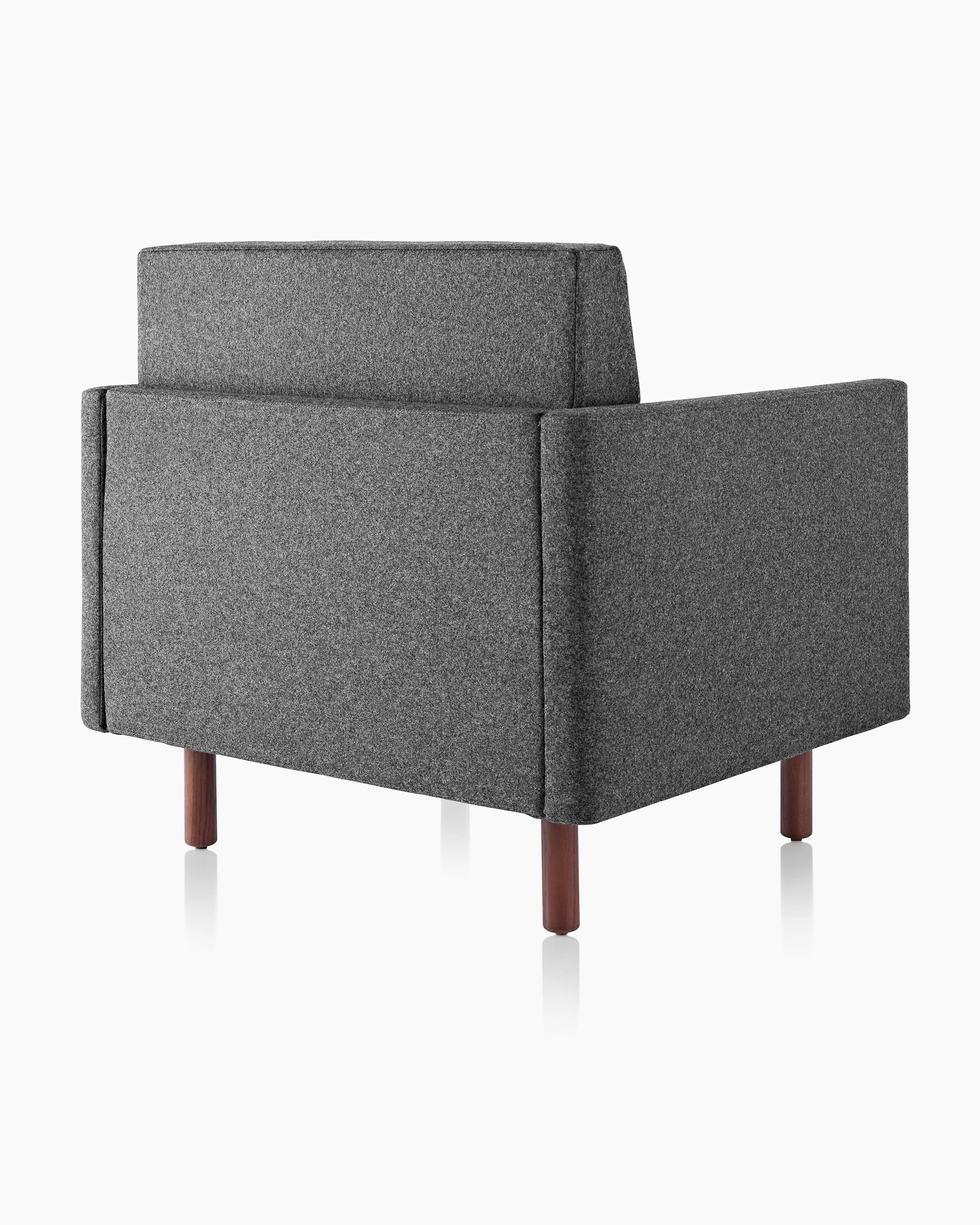 A Tuxedo Classic club chair upholstered in dark gray fabric, viewed from behind at an angle.