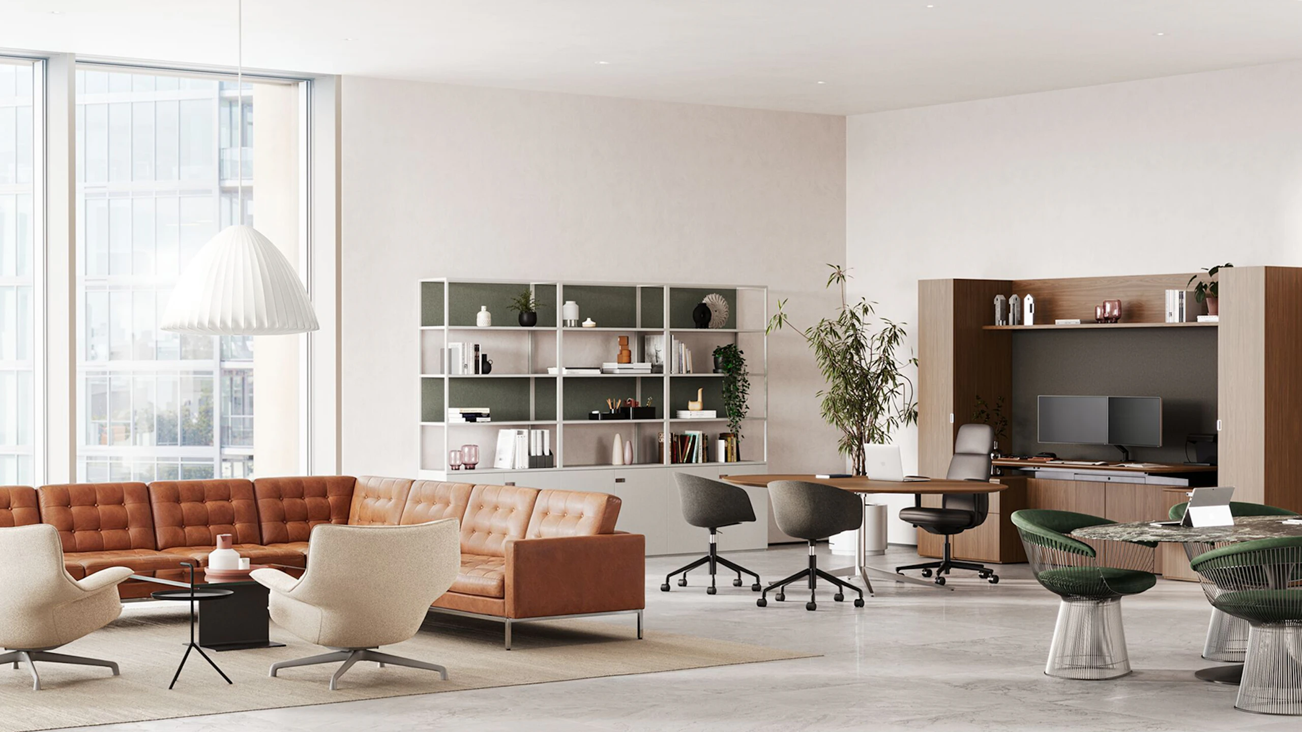 A large private office with a Knoll Konzert Collection and Asari Chair, a lounge setting with a Florence Knoll relaxed corner sofa, and a meeting setting with a Saarinen Table and Platner side chairs.