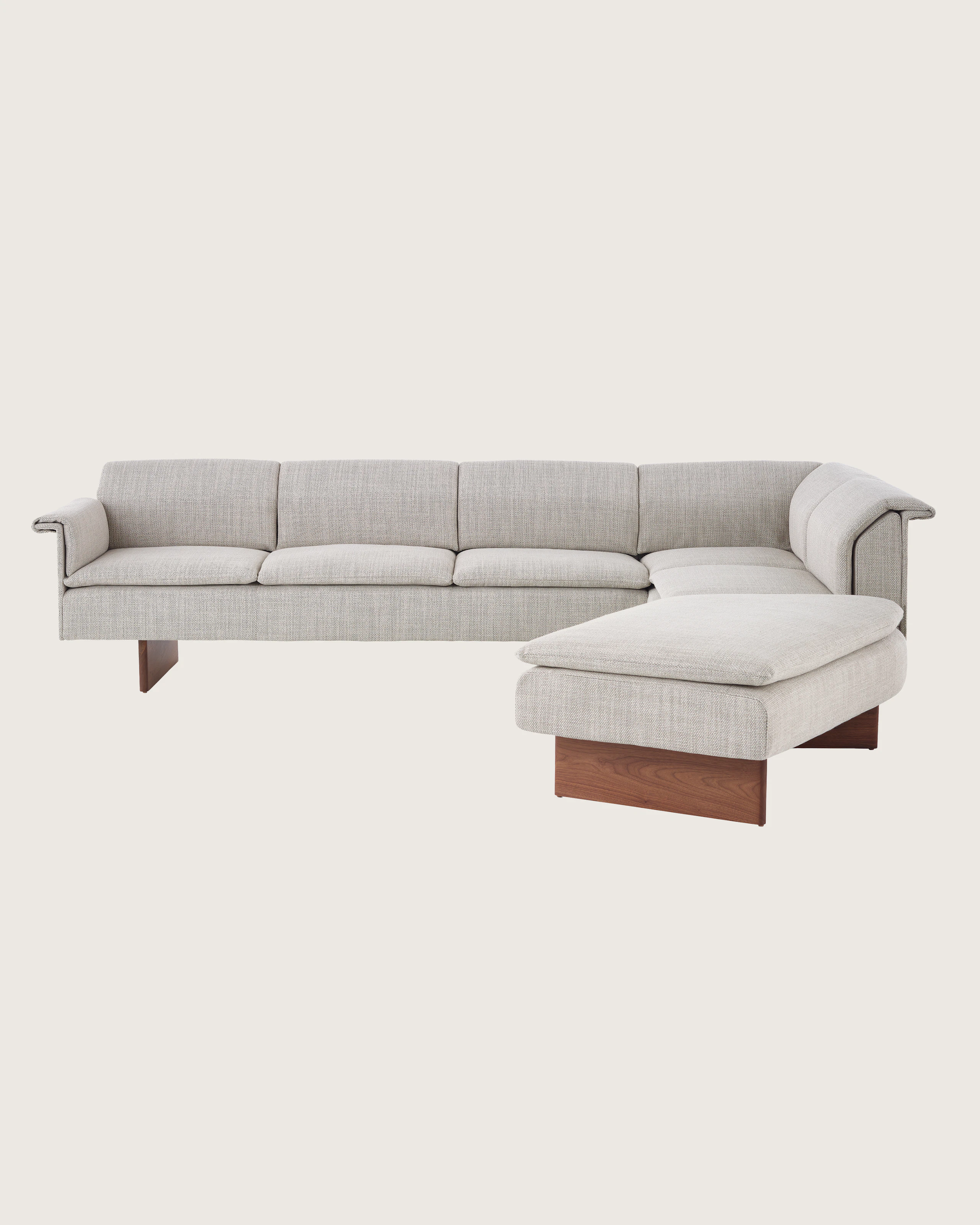 Mantle L-Shaped Sofa in Capri Stone with Walnut Wood Base.