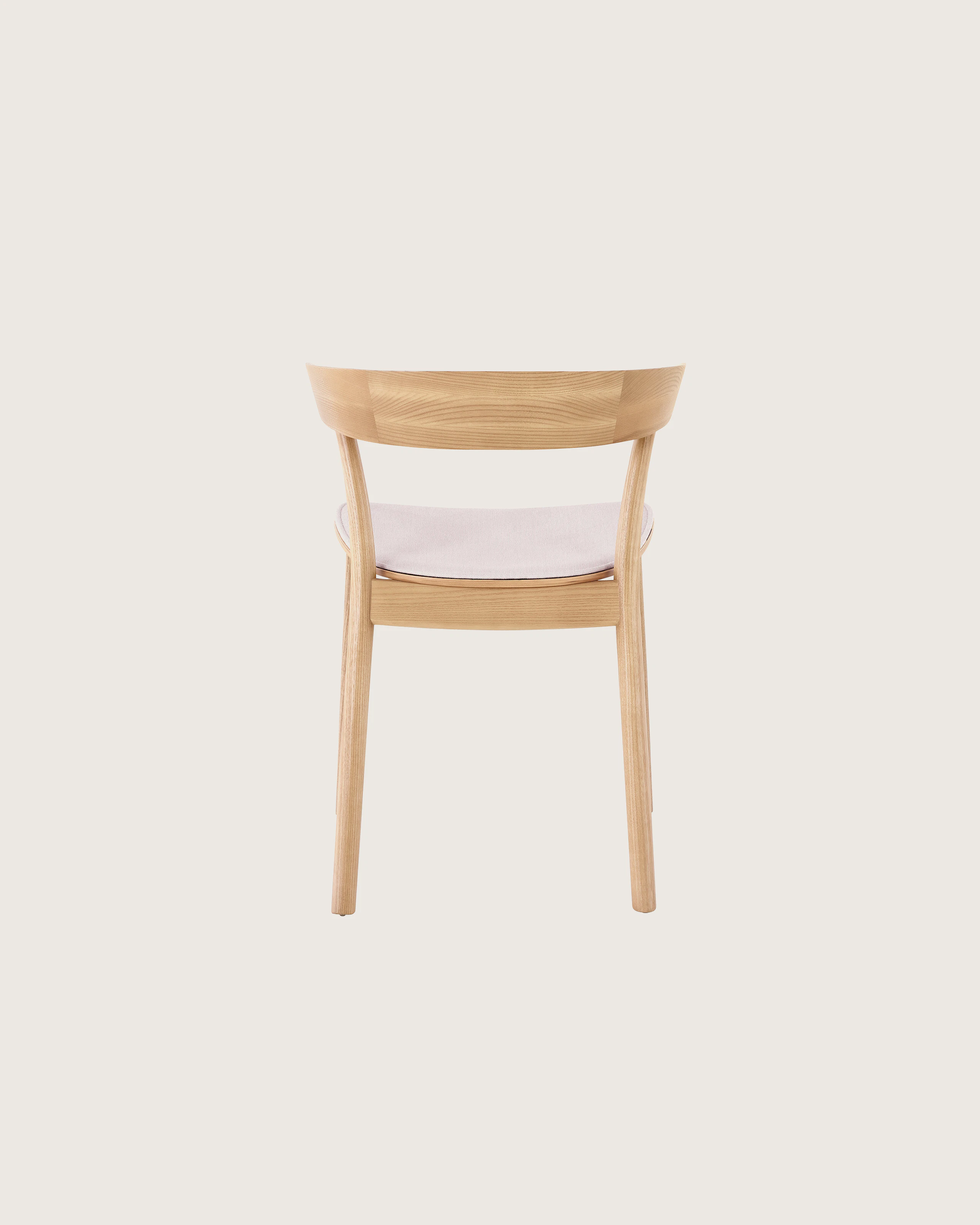 An oak colored Leeway Chair featuring a pink seat cushion.
