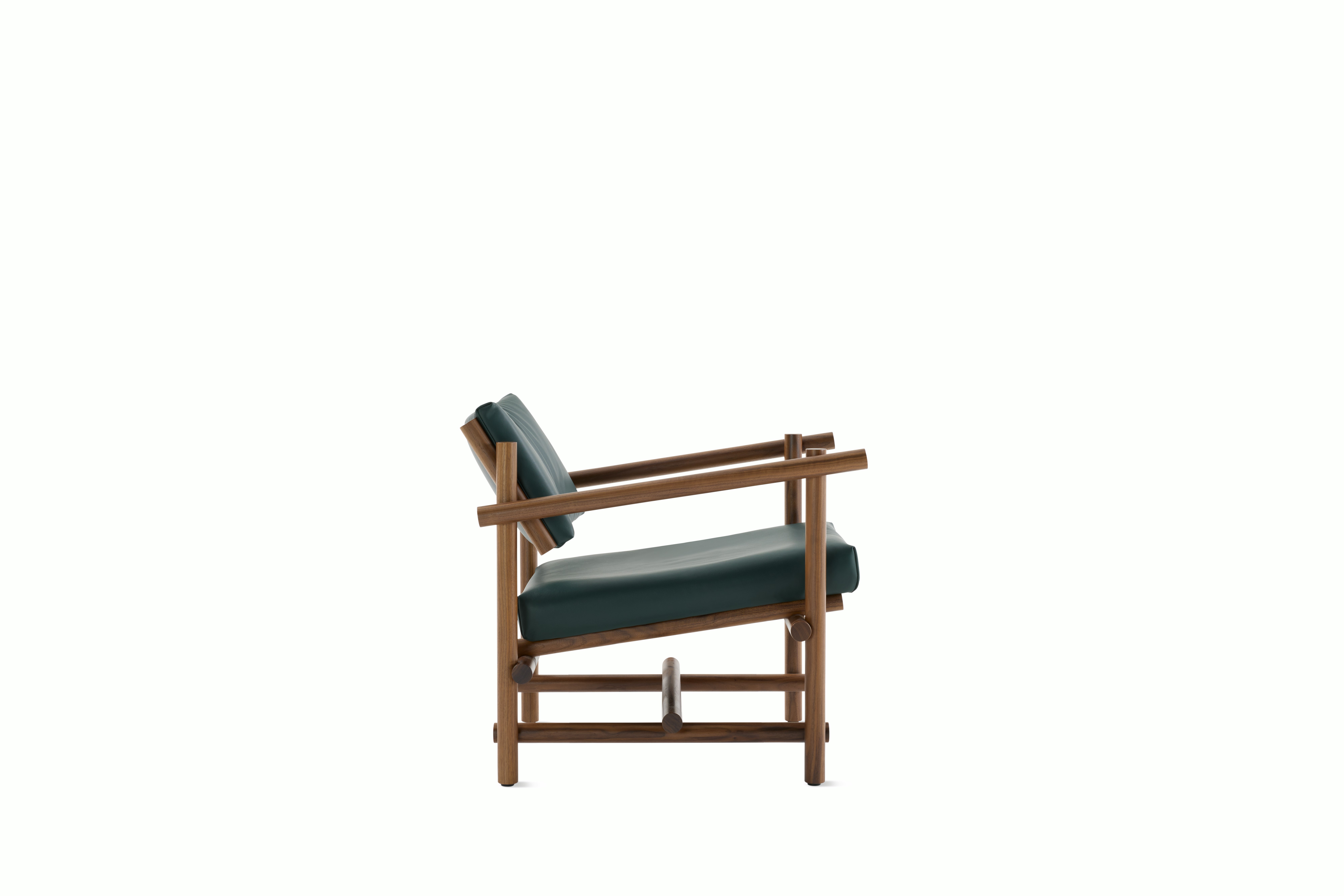 A Muecke Lounge Chair in Forest Green Walnut viewed from the side.