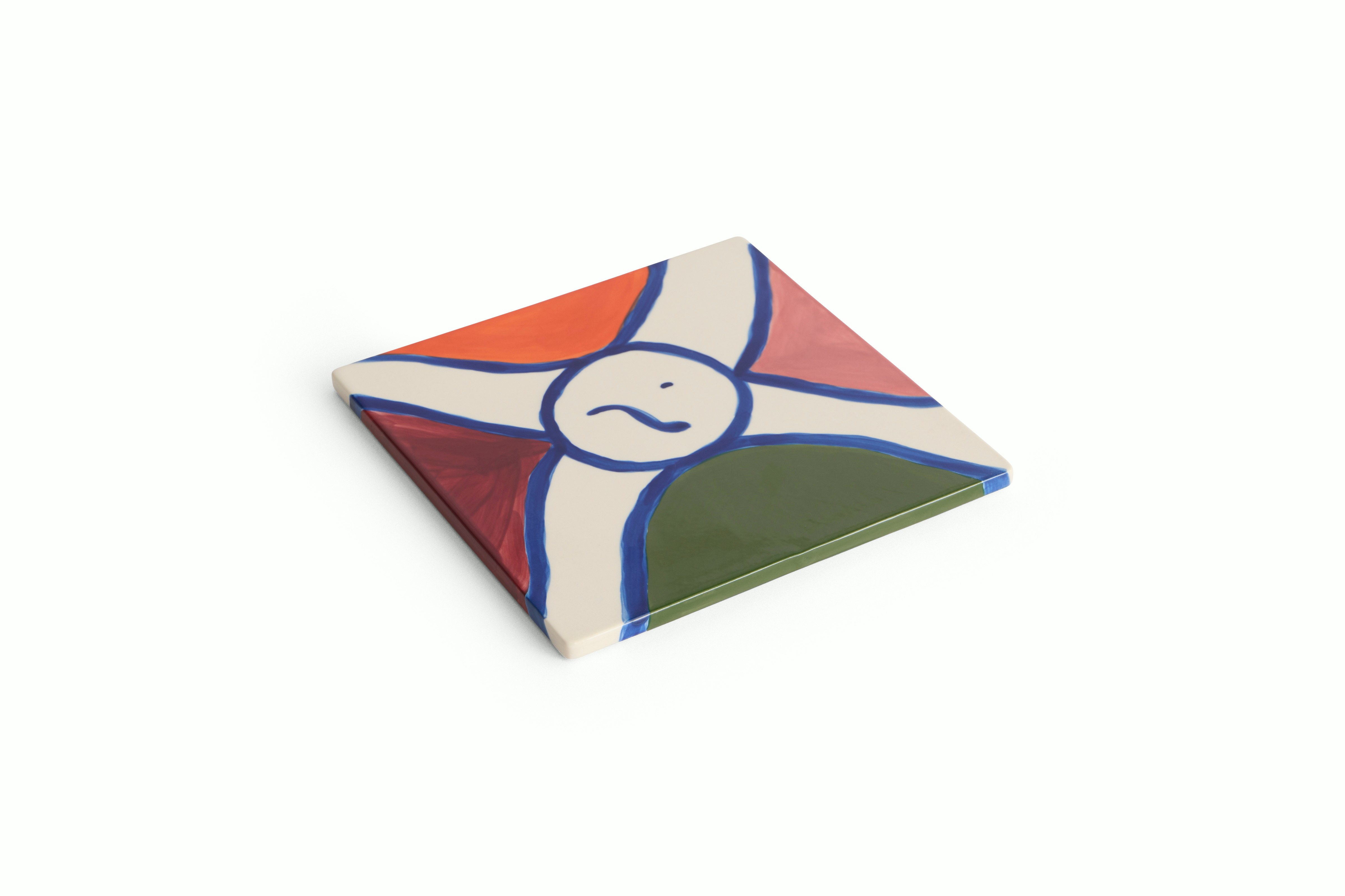 A Stained Glass Trivet in Stoneware viewed from an angle.