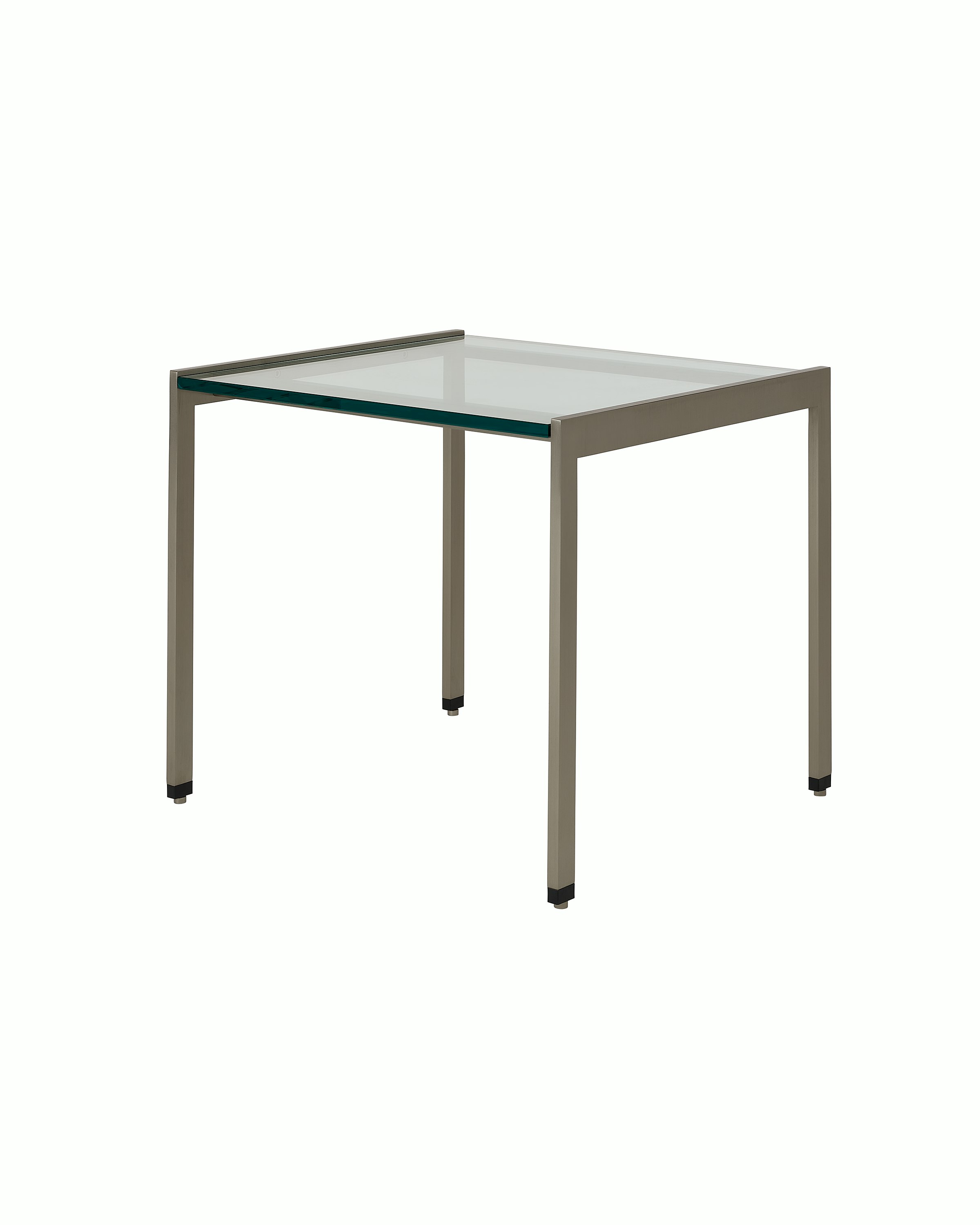 H Frame Side Table designed by Ward Bennett with a satin chrome base and a clear glass top, shown at an angle on a white sweep.