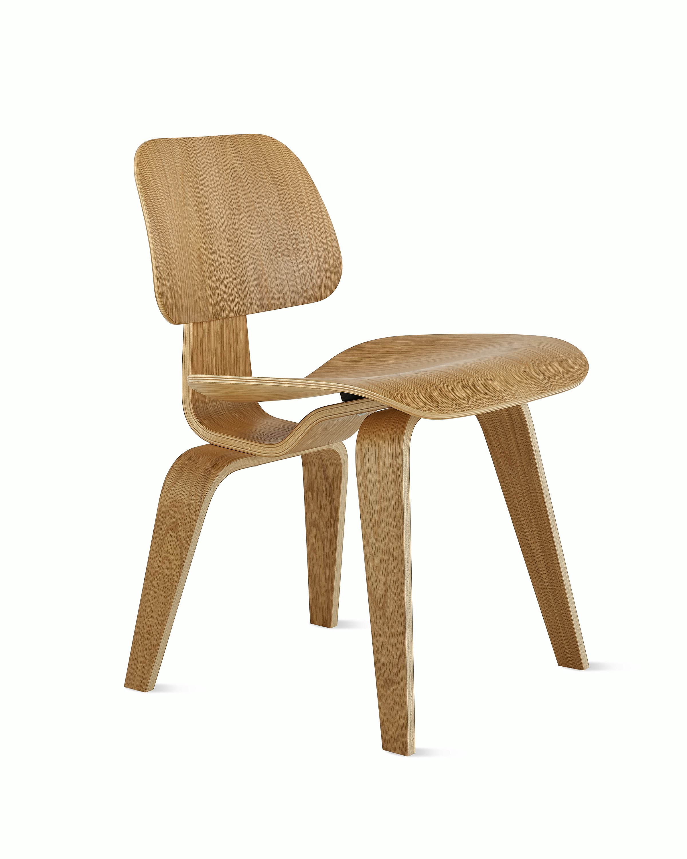 An Eames Molded Plywood Dining Chair in White Oak viewed at an angle