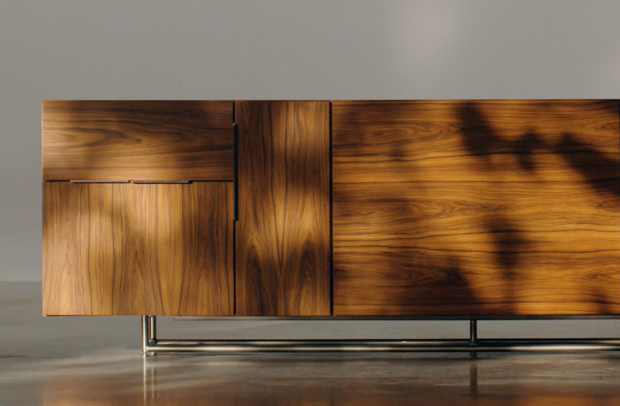 Domino Credenza in Natural Walnut in a studio setting, viewed from the front.