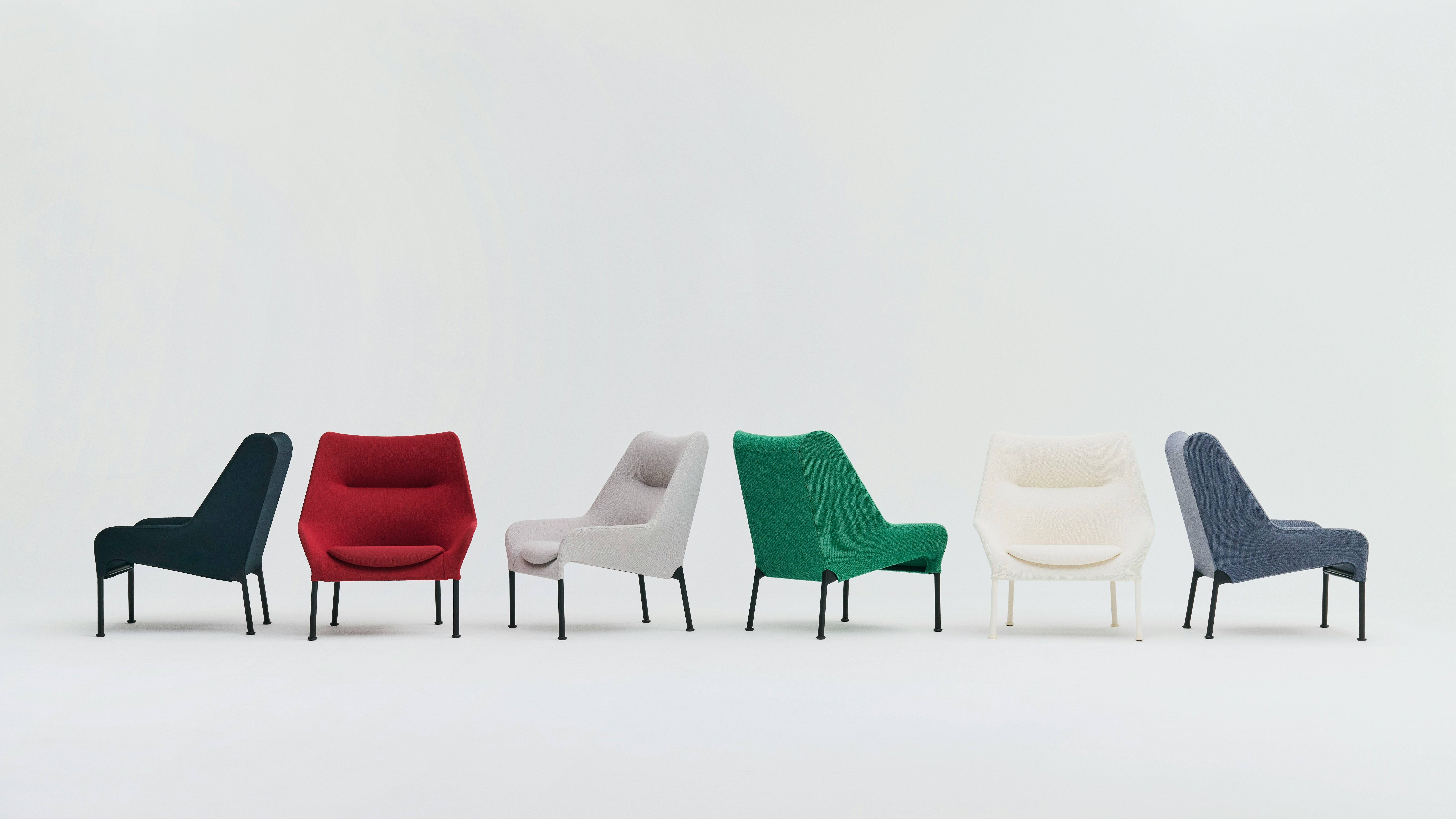Family of O2 Lounge Chairs in red, green, black, and white arranged on seamless white backdrop.