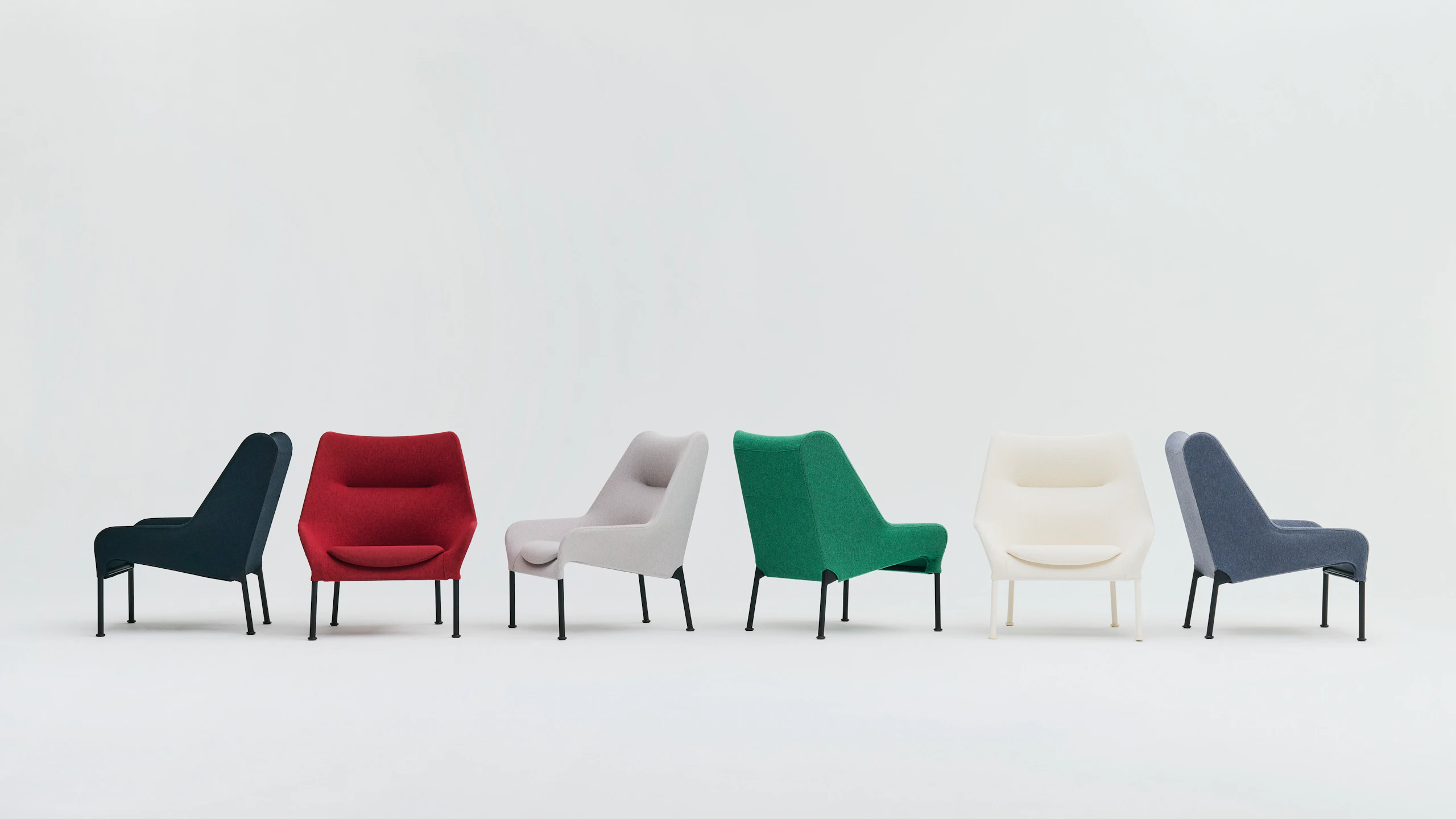 Family of O2 Lounge Chairs in red, green, black, and white arranged on seamless white backdrop.