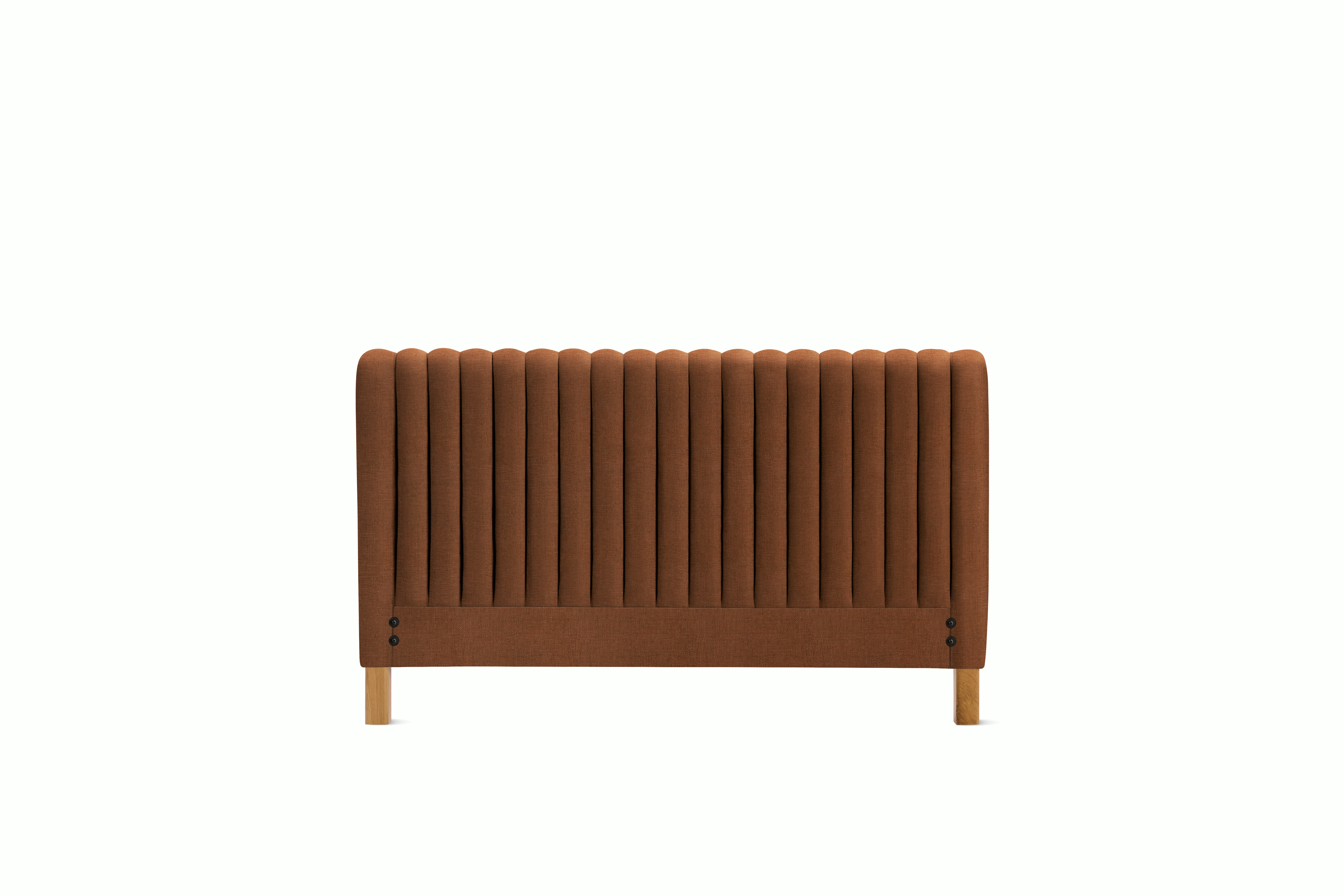 A Charlotte Headboard in Rattan viewed from an angle.